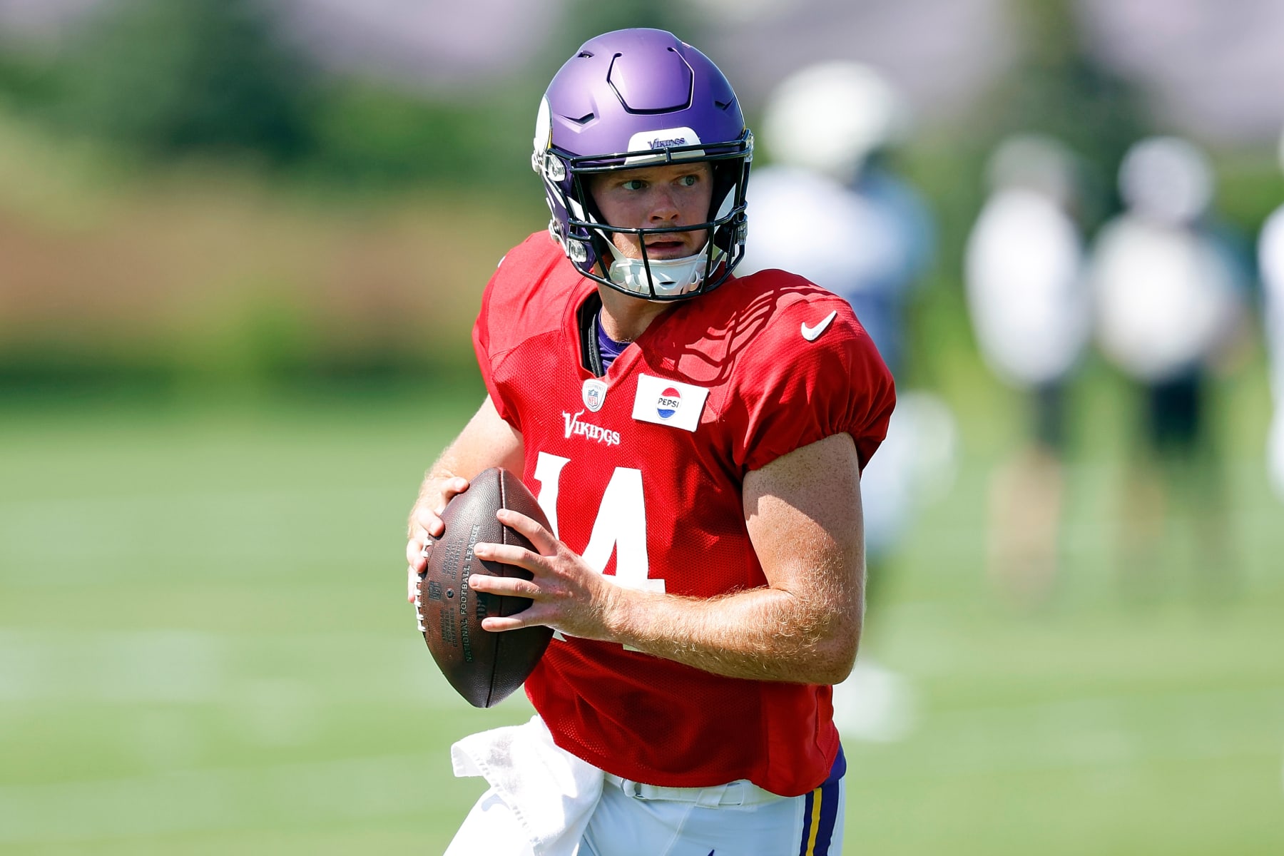 EAGAN, MINNESOTA - AUGUST 02: Sam Darnold #14 of the Minnesota Vikings participates in a drill during training camp on August 02, 2024 in Eagan, Minnesota. (Photo by David Berding/Getty Images)