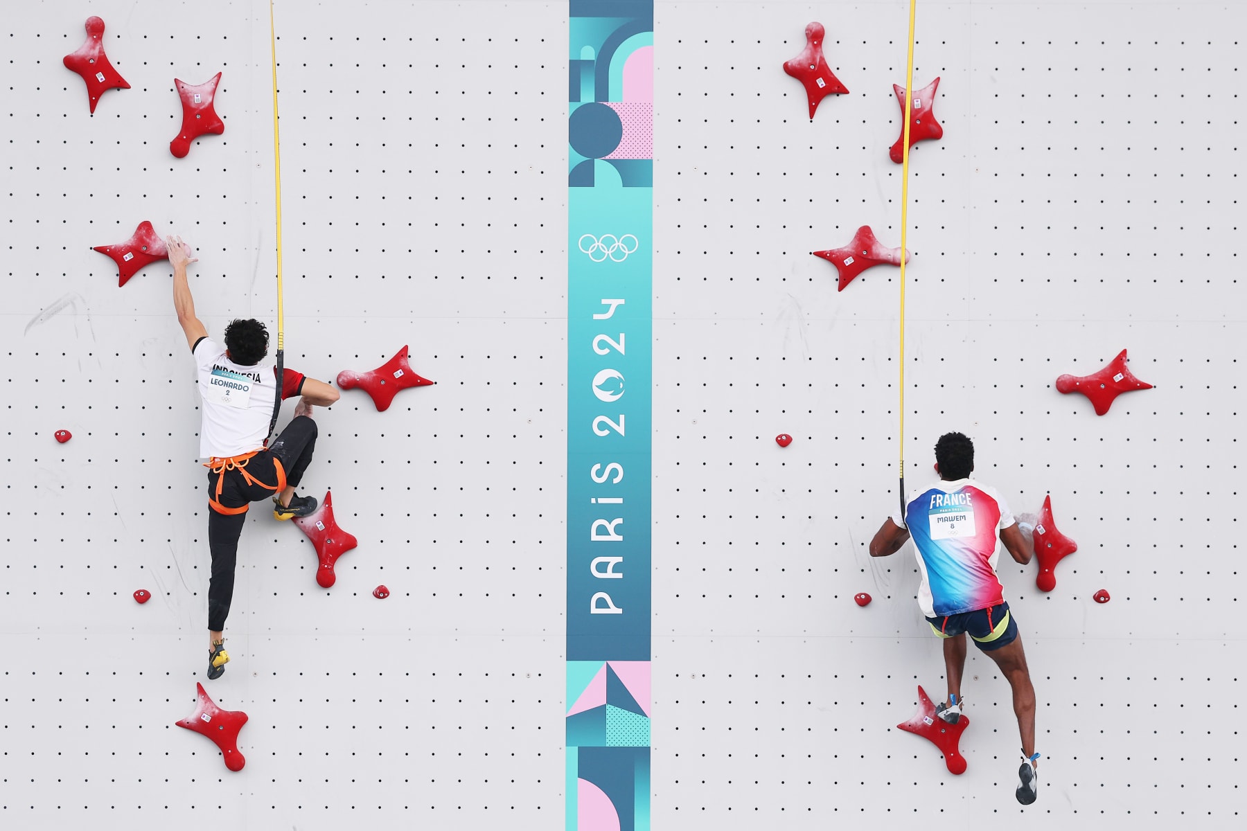 PARIS, FRANCE - AUGUST 08: Veddriq Leonardo of Team Indonesia and Bassa Mawem of Team France climb during the Men's Speed - Quarterfinals on day thirteen of the Olympic Games Paris 2024 at Le Bourget Sport Climbing Venue on August 08, 2024 in Paris, France. (Photo by Michael Reaves/Getty Images)