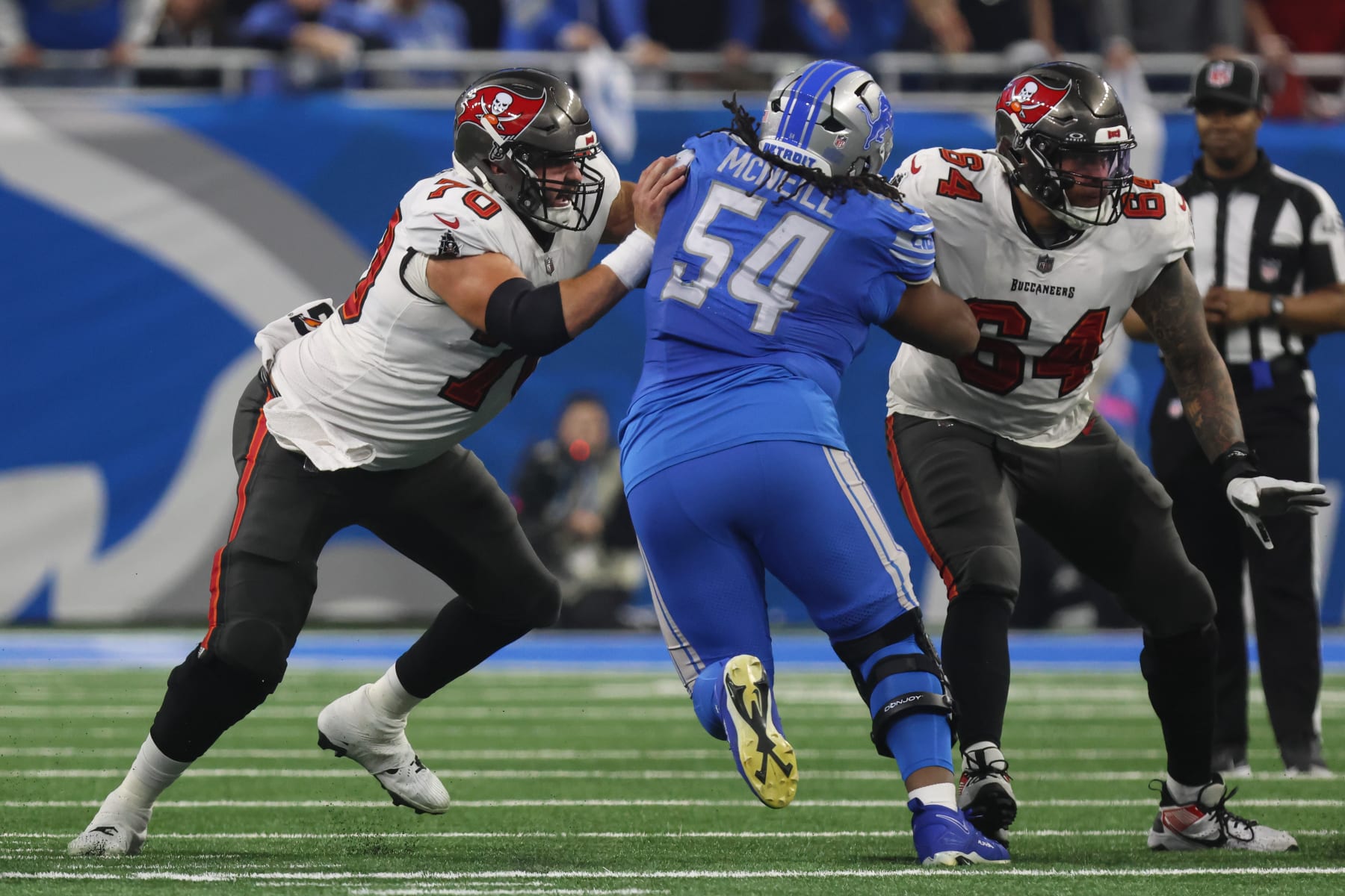 DETROIT, MI - JANUARY 21:  Tampa Bay Buccaneers center Robert Hainsey (70) blocks Detroit Lions defensive tackle Alim McNeill (54) while Tampa Bay Buccaneers guard Aaron Stinnie (64) blocks during a play during an NFL NFC Divisional playoff football game between the Tampa Bay Buccaneers and the Detroit Lions on January 21, 2024 at Ford Field in Detroit, Michigan. (Photo by Scott W. Grau/Icon Sportswire via Getty Images)