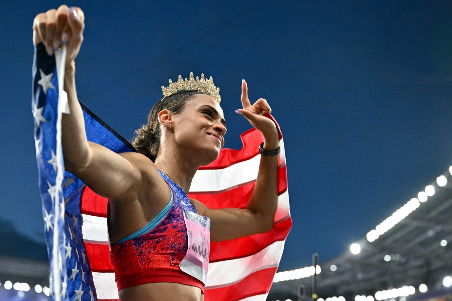 Gold medallist US' Sydney Mclaughlin-Levrone wears a crown as she celebrates winning the women's 400m hurdles final of the athletics event and setting a new world record during the Paris 2024 Olympic Games at Stade de France in Saint-Denis, north of Paris, on August 8, 2024. (Photo by Andrej ISAKOVIC / AFP) (Photo by ANDREJ ISAKOVIC/AFP via Getty Images)