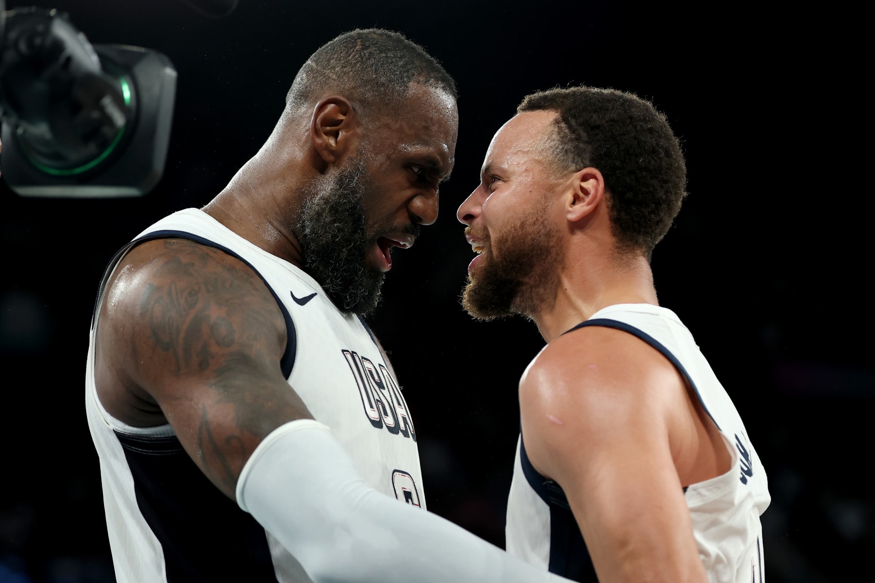 PARIS, FRANCE - AUGUST 08: Lebron James #6 and Stephen Curry #4 of Team United States celebrate after their team's win against Team Serbia during a Men's basketball semifinals match between Team United States and Team Serbia on day thirteen of the Olympic Games Paris 2024 at Bercy Arena on August 08, 2024 in Paris, France. (Photo by Gregory Shamus/Getty Images)