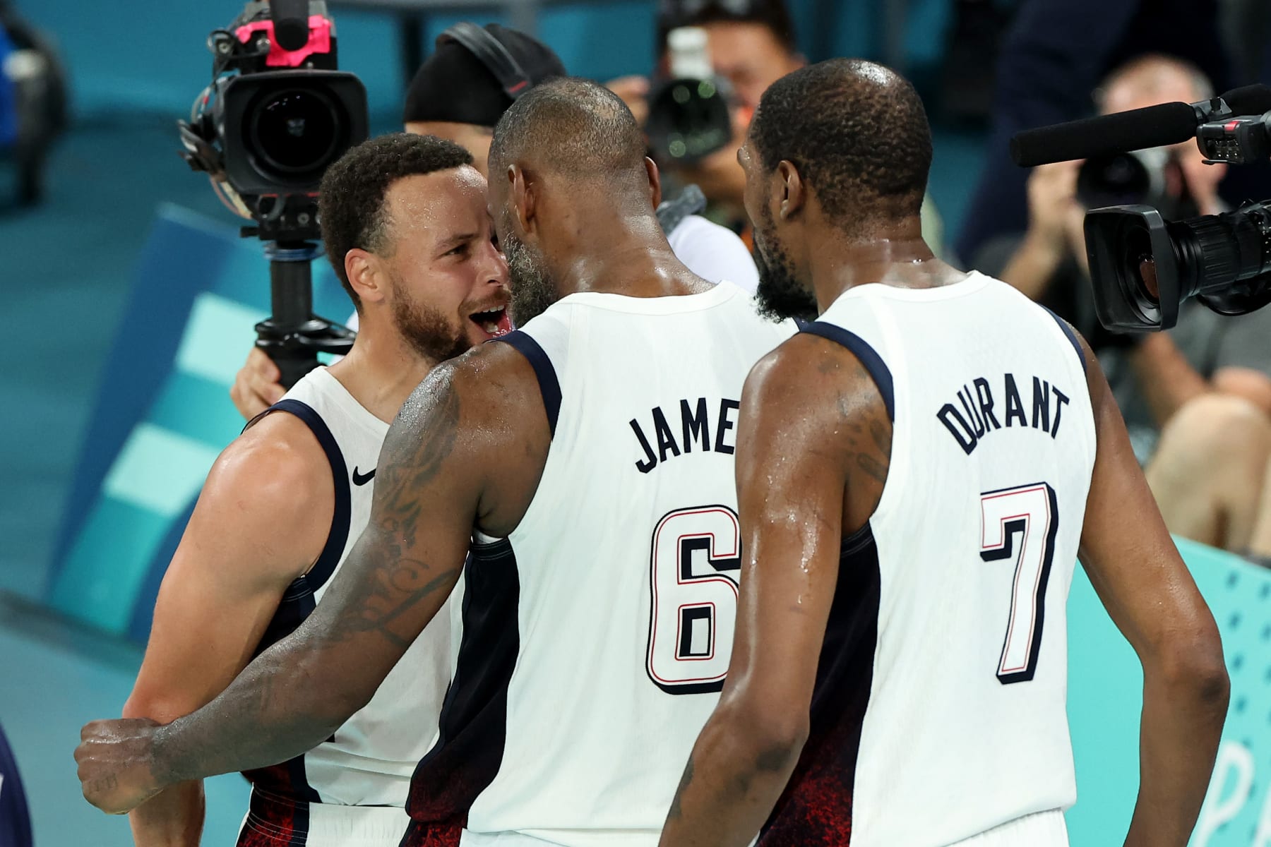 PARIS, FRANCE - AUGUST 08: Lebron James #6 and Stephen Curry #4 of Team United States react after winning a Men's basketball semifinals match between Team United States and Team Serbia on day thirteen of the Olympic Games Paris 2024 at Bercy Arena on August 08, 2024 in Paris, France. (Photo by Arturo Holmes/Getty Images)