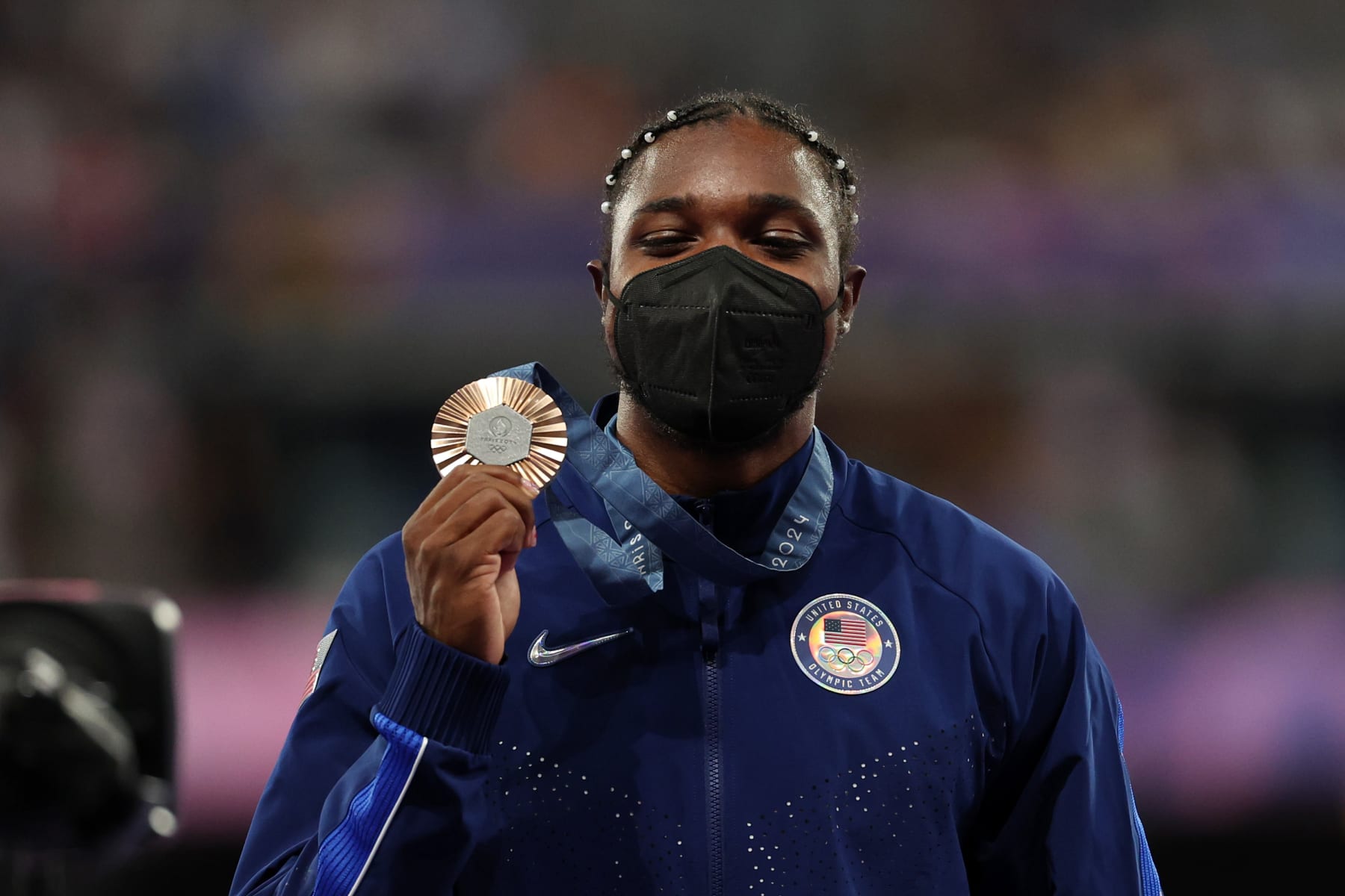 PARIS, FRANCE - AUGUST 09: Bronze medalist Noah Lyles of Team United States celebrates on the podium during the Men's 200m medal ceremony on day fourteen of the Olympic Games Paris 2024 at Stade de France on August 09, 2024 in Paris, France. (Photo by Patrick Smith/Getty Images)