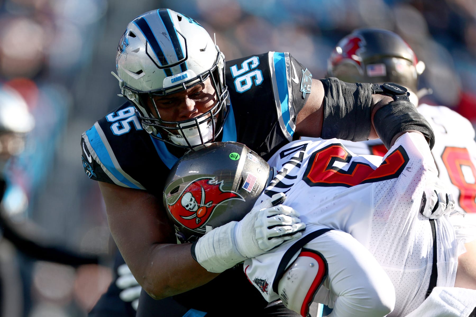CHARLOTTE, NORTH CAROLINA - JANUARY 07: Derrick Brown #95 of the Carolina Panthers tackles Baker Mayfield #6 of the Tampa Bay Buccaneers during the third quarter at Bank of America Stadium on January 07, 2024 in Charlotte, North Carolina. (Photo by Jared C. Tilton/Getty Images)