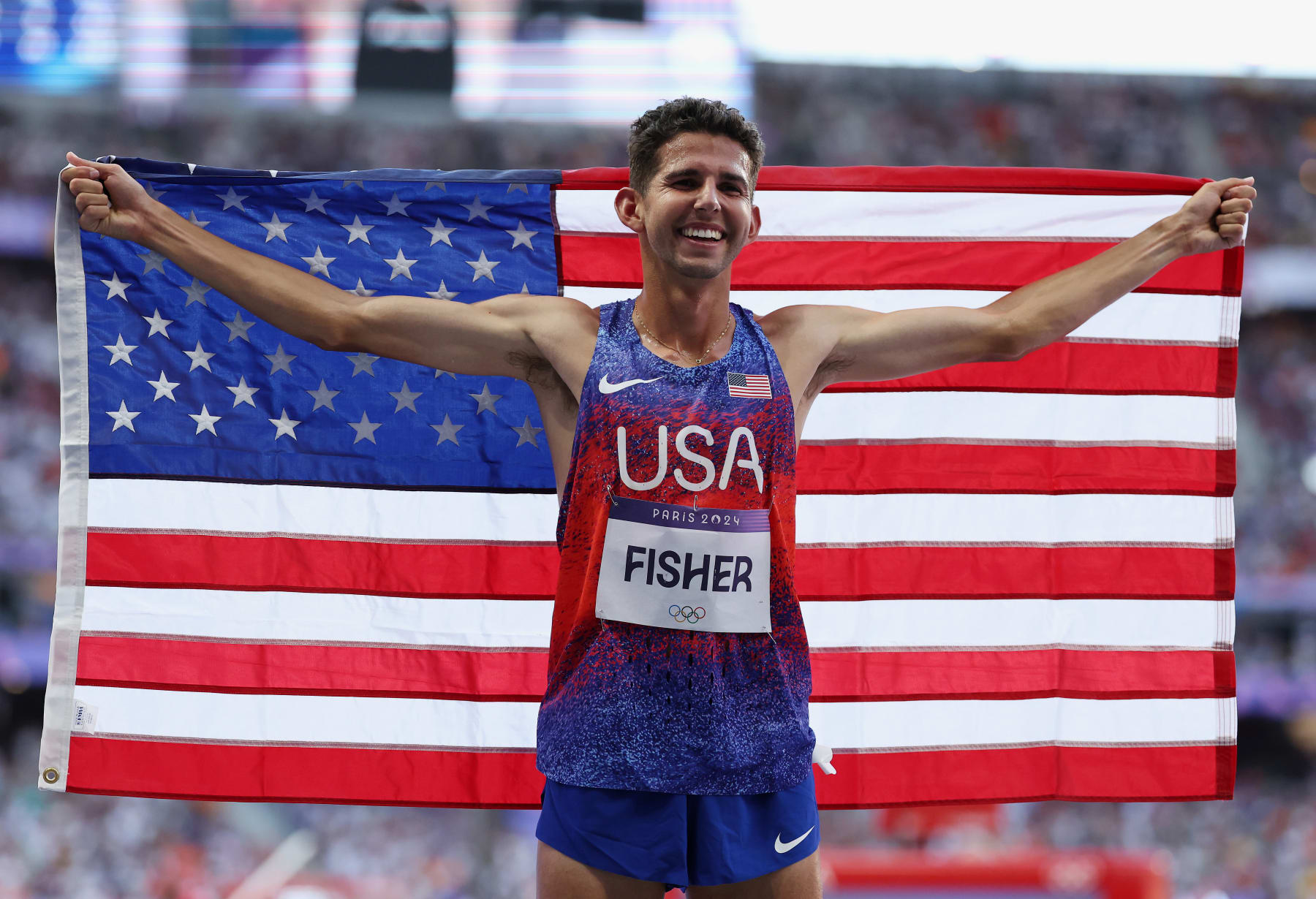 PARIS, FRANCE - AUGUST 10: Bronze medalist Grant Fisher of Team United States celebrates following the Men's 5000m Final on day fifteen of the Olympic Games Paris 2024 at Stade de France on August 10, 2024 in Paris, France. (Photo by Hannah Peters/Getty Images)