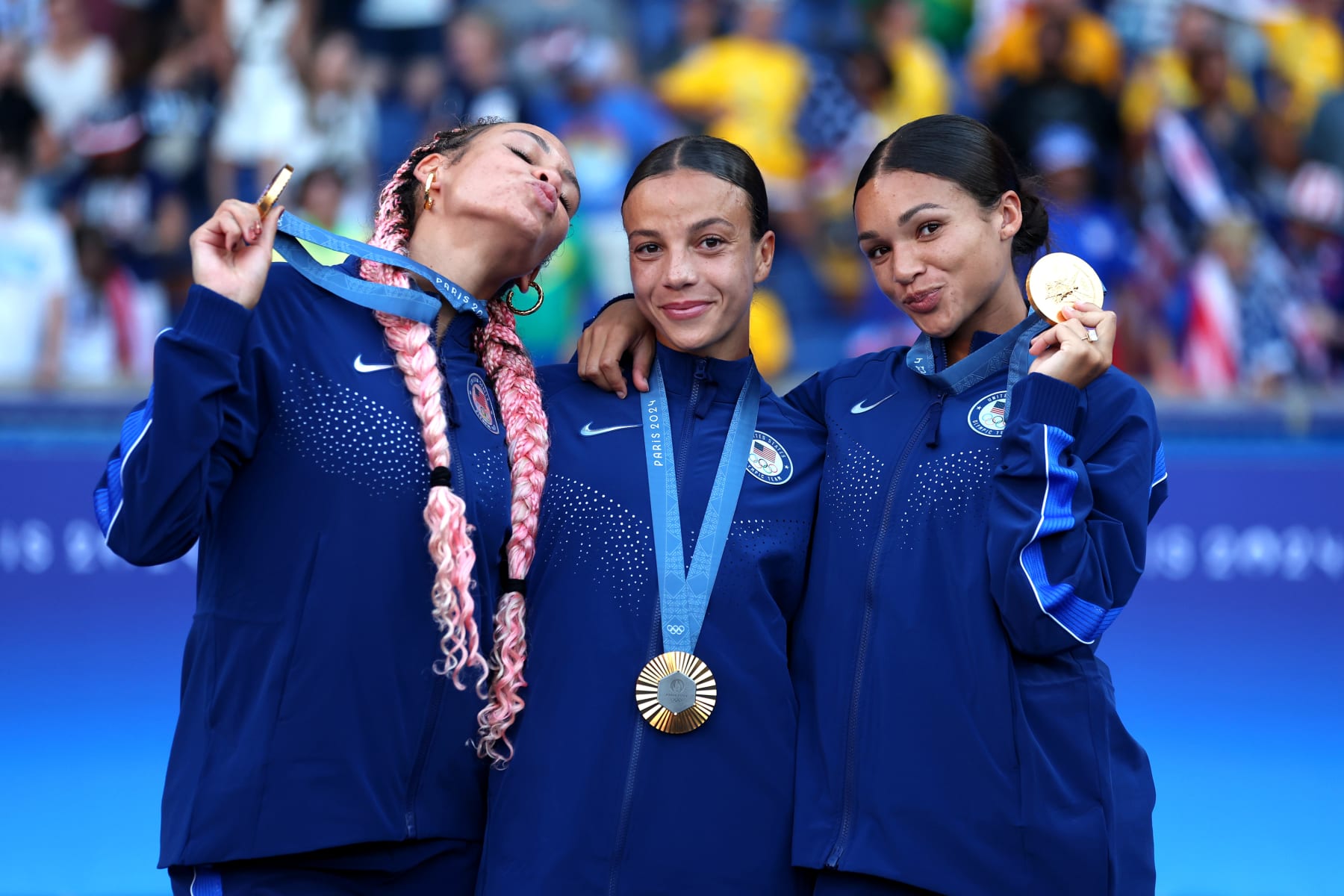 PARIS, FRANCE - AUGUST 10: (L-R) Gold Medalists Trinity Rodman #5, Mallory Swanson #9, Sophia Smith #11 of Team United States pose for a photo with the medals after the Women's Football medal ceremony following the Women's Gold Medal match between Brazil and United States of America during the Olympic Games Paris 2024 at Parc des Princes on August 10, 2024 in Paris, France. (Photo by Carl Recine/Getty Images)
