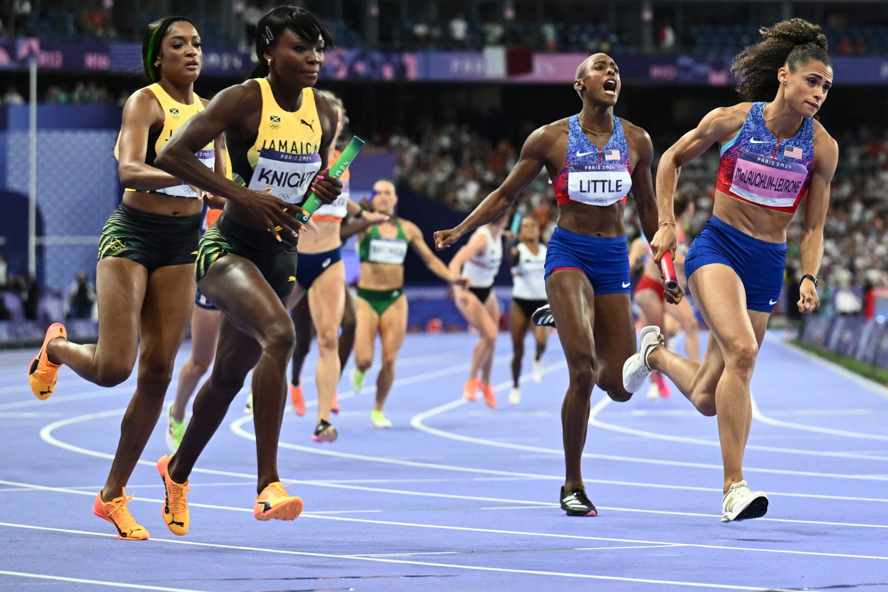 Jamaica's Andrenette Knight, US' Shamier Little and US' Sydney Mclaughlin-Levrone compete in the women's 4x400m relay final of the athletics event at the Paris 2024 Olympic Games at Stade de France in Saint-Denis, north of Paris, on August 10, 2024. (Photo by Jewel SAMAD / AFP) (Photo by JEWEL SAMAD/AFP via Getty Images)