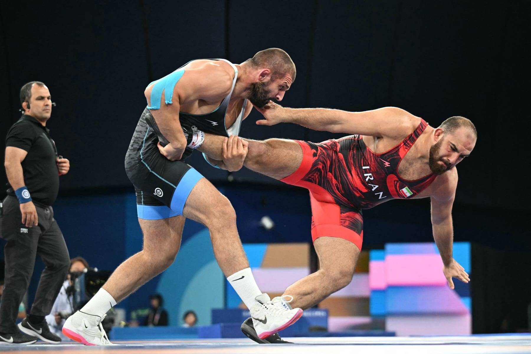 Iran's Amir Hossein Zare (red) wrestles Georgia's Geno Petriashvili (blue) in their men's freestyle 125kg wrestling final match at the Champ-de-Mars Arena during the Paris 2024 Olympic Games, in Paris on August 10, 2024. (Photo by Punit PARANJPE / AFP) (Photo by PUNIT PARANJPE/AFP via Getty Images)