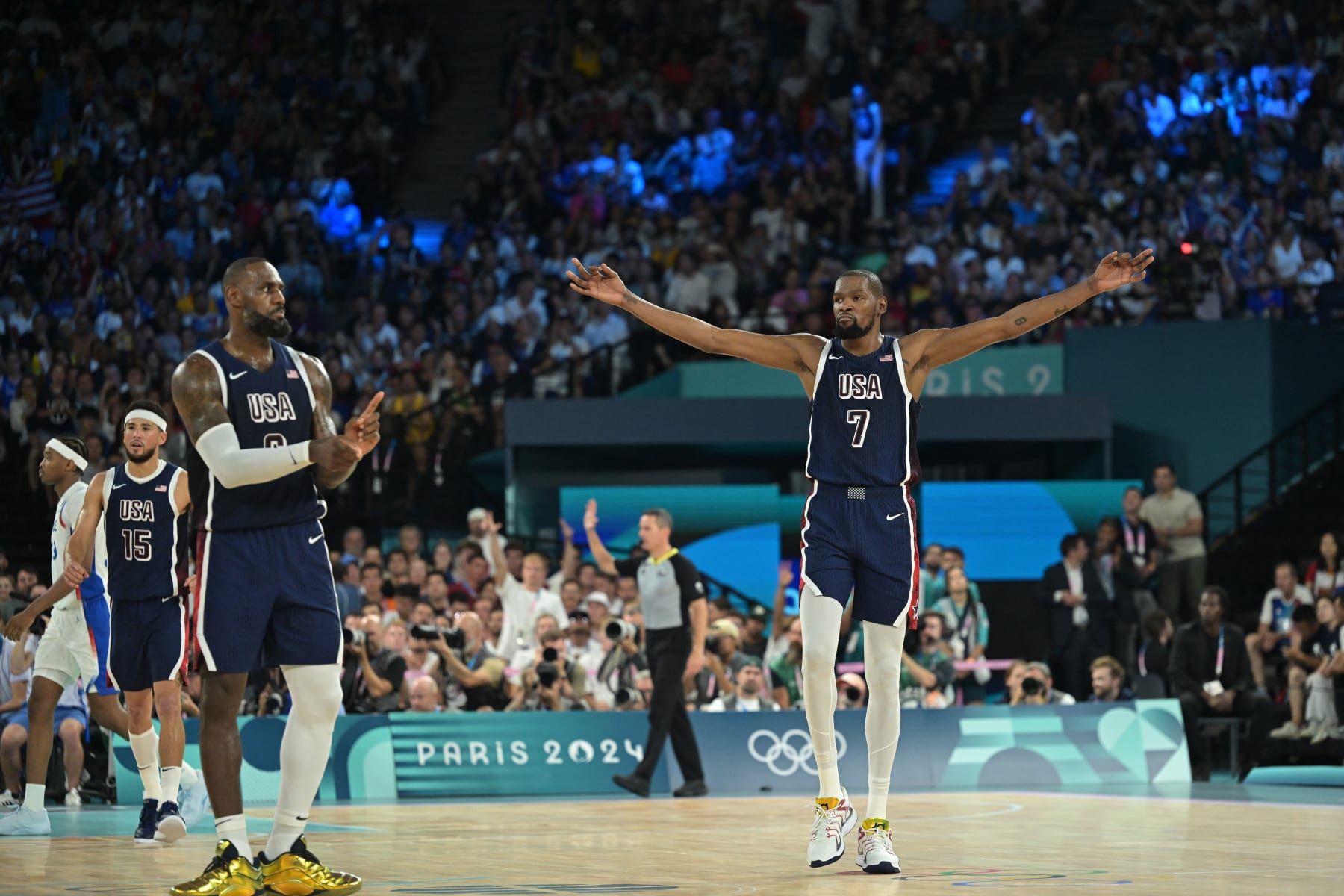USA's #06 LeBron James (L) reacts as USA's #07 Kevin Durant (R) celebrates after scoring in the men's Gold Medal basketball match between France and USA during the Paris 2024 Olympic Games at the Bercy  Arena in Paris on August 10, 2024. (Photo by Damien MEYER / AFP) (Photo by DAMIEN MEYER/AFP via Getty Images)