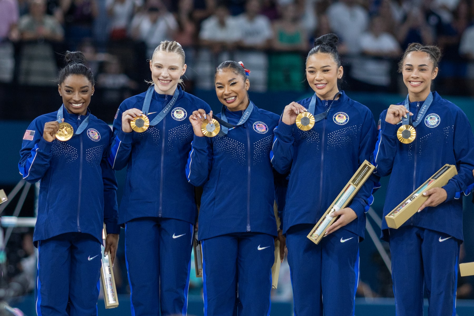 PARIS, FRANCE: JULY 30:  The United States team of Simone Biles, Jade Carey,  Jordan Chiles, Sunisa Lee, and Hezly Rivera on the podium with their gold medals after the team's victory during the Artistic Gymnastics Team Final for Women at the Bercy Arena during the Paris 2024 Summer Olympic Games on July 30th, 2024 in Paris, France. (Photo by Tim Clayton/Corbis via Getty Images)