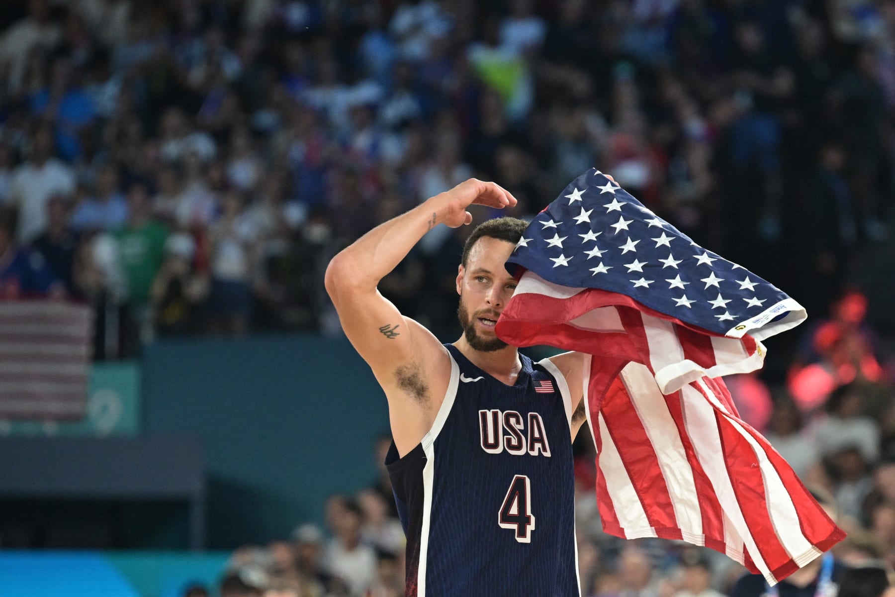 USA's #04 Stephen Curry celebrates after the USA won the men's Gold Medal basketball match between France and USA during the Paris 2024 Olympic Games at the Bercy  Arena in Paris on August 10, 2024. (Photo by Damien MEYER / AFP) (Photo by DAMIEN MEYER/AFP via Getty Images)