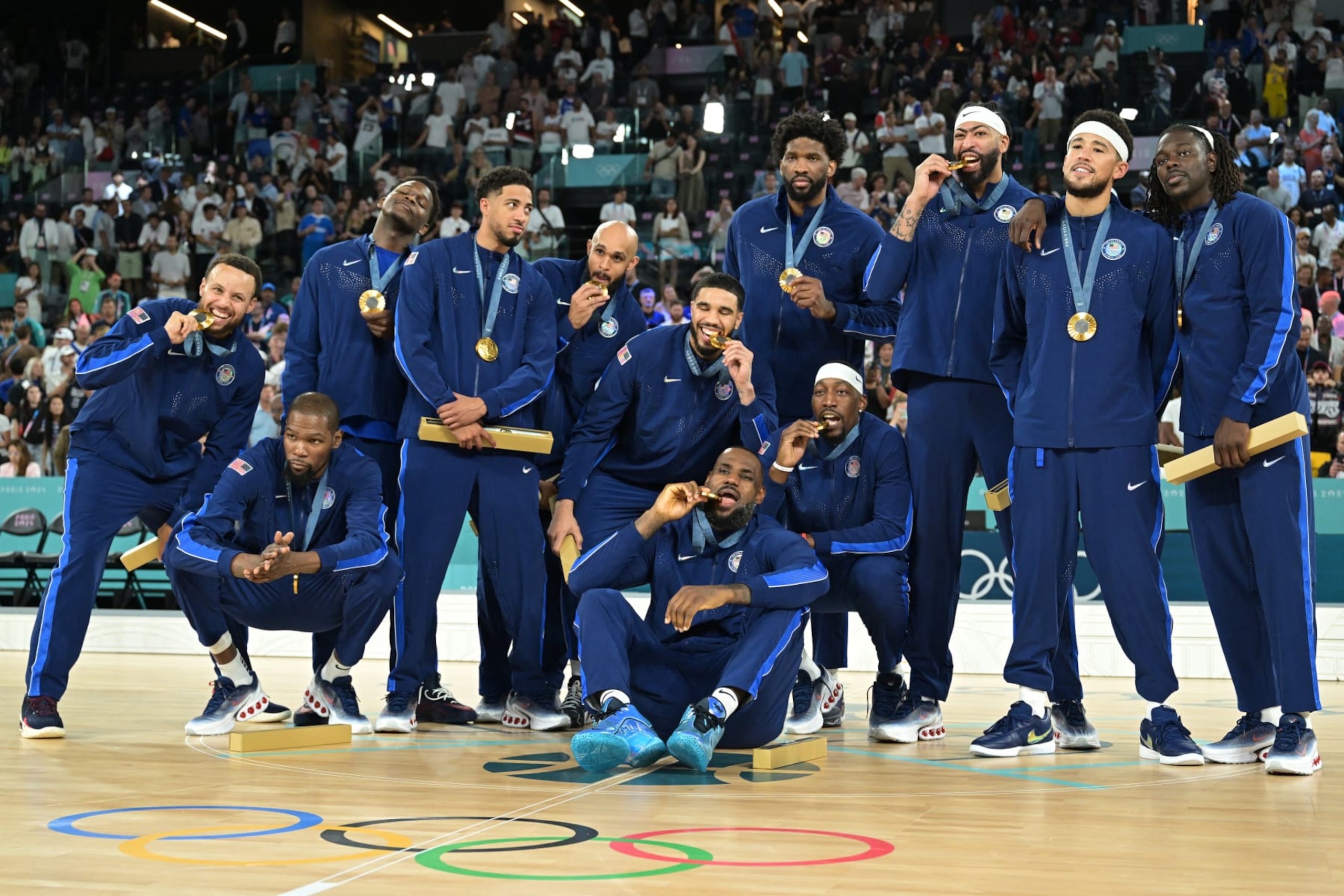 Gold medallists (From L) USA's #04 Stephen Curry, USA's #07 Kevin Durant, USA's #05 Anthony Edwards, USA's #09 Tyrese Haliburton, USA's #08 Derrick White, USA's #10 Jayson Tatum, USA's #06 LeBron James, USA's #11 Joel Embiid, USA's #13 Bam Adebayo, USA's #14 Anthony Davis, USA's #15 Devin Booker and USA's #12 Jrue Holiday pose after the men's Gold Medal basketball match between France and USA during the Paris 2024 Olympic Games at the Bercy  Arena in Paris on August 10, 2024. (Photo by Damien MEYER / AFP) (Photo by DAMIEN MEYER/AFP via Getty Images)