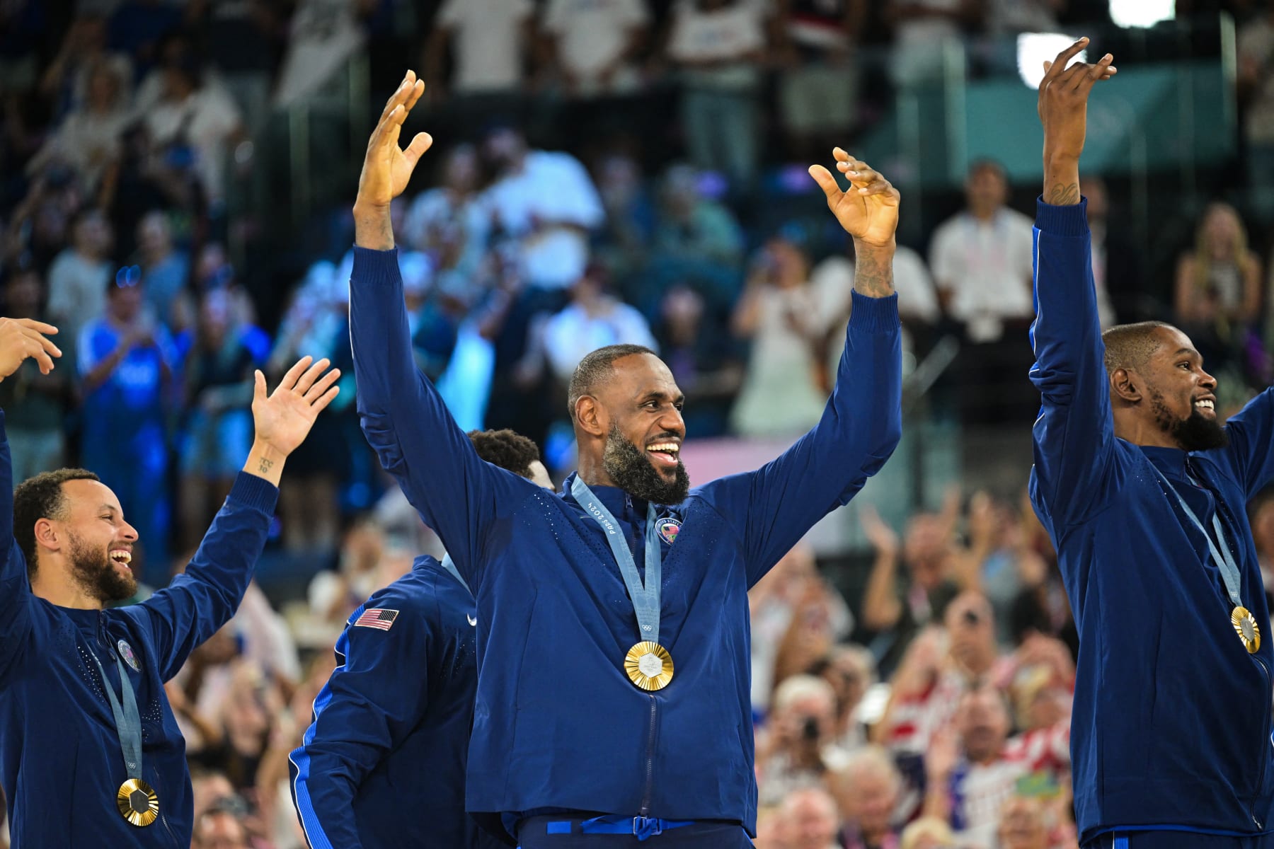 Gold medallists (From L) USA's #04 Stephen Curry, USA's #06 LeBron James and USA's #07 Kevin Durant celebrate on the podium after the men's Gold Medal basketball match between France and USA during the Paris 2024 Olympic Games at the Bercy  Arena in Paris on August 10, 2024. (Photo by Damien MEYER / AFP) (Photo by DAMIEN MEYER/AFP via Getty Images)