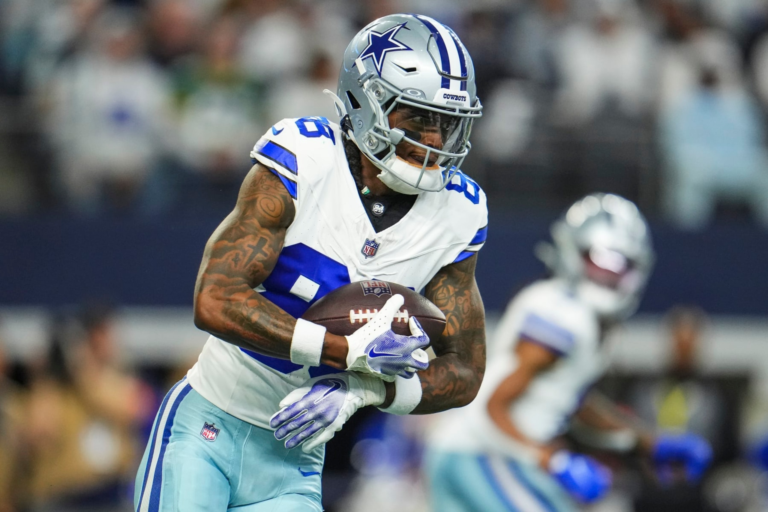 DALLAS, TX - JANUARY 14: CeeDee Lamb #88 of the Dallas Cowboys runs the ball during an NFL wild-card playoff football game against the Green Bay Packers at AT&T Stadium on January 14, 2024 in Dallas, Texas. (Photo by Cooper Neill/Getty Images)