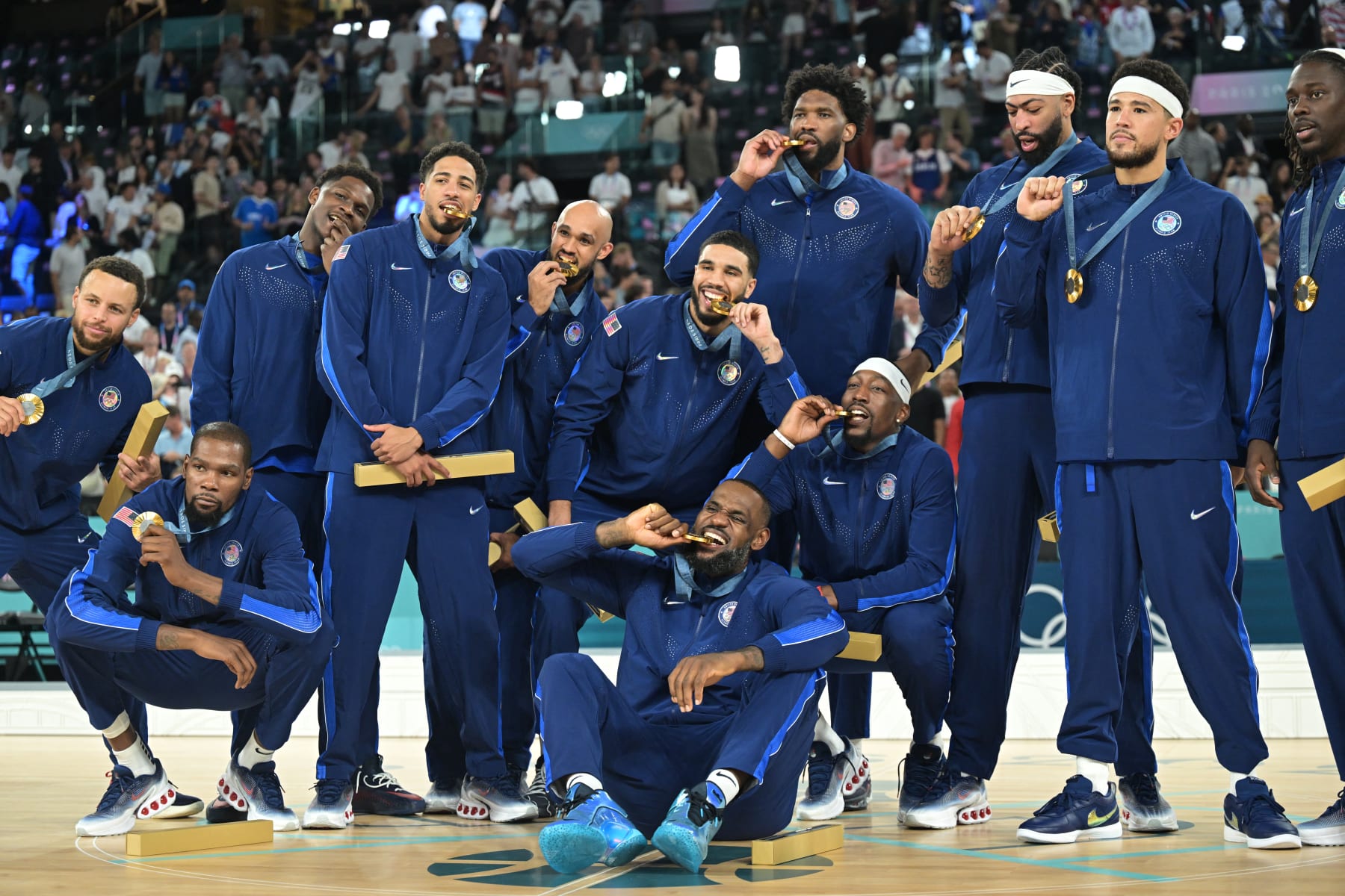 TOPSHOT - Gold medallists (From L) USA's #04 Stephen Curry, USA's #07 Kevin Durant, USA's #05 Anthony Edwards, USA's #09 Tyrese Haliburton, USA's #08 Derrick White, USA's #10 Jayson Tatum, USA's #06 LeBron James, USA's #11 Joel Embiid, USA's #13 Bam Adebayo, USA's #14 Anthony Davis, USA's #15 Devin Booker and USA's #12 Jrue Holiday pose on the podium after the men's Gold Medal basketball match between France and USA during the Paris 2024 Olympic Games at the Bercy  Arena in Paris on August 10, 2024. (Photo by Damien MEYER / AFP) (Photo by DAMIEN MEYER/AFP via Getty Images)