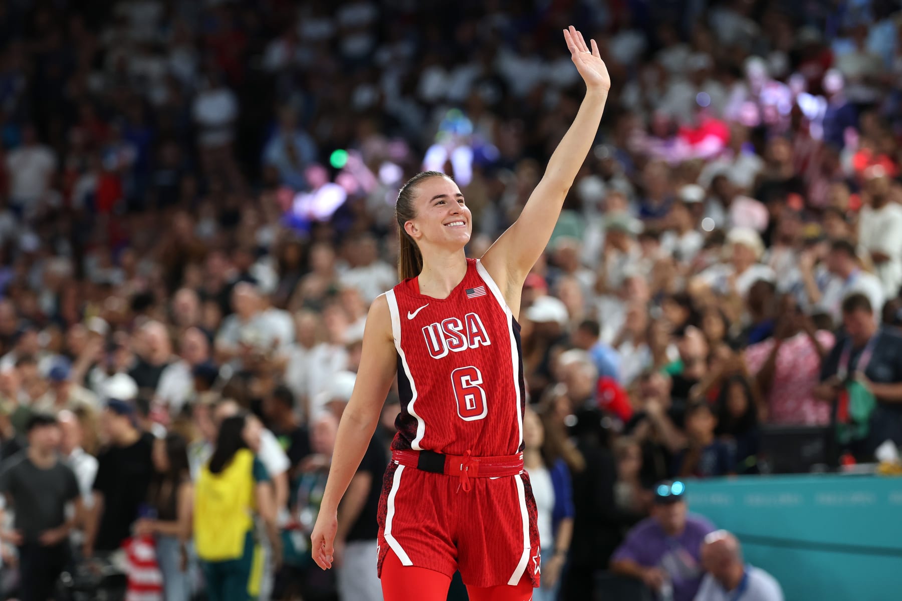 PARIS, FRANCE - AUGUST 11: Sabrina Ionescu #6 of Team United States waves to the crowd after her team's victory against Team France during the Women's Gold Medal game between Team France and Team United States on day sixteen of the Olympic Games Paris 2024 at Bercy Arena on August 11, 2024 in Paris, France. (Photo by Gregory Shamus/Getty Images)