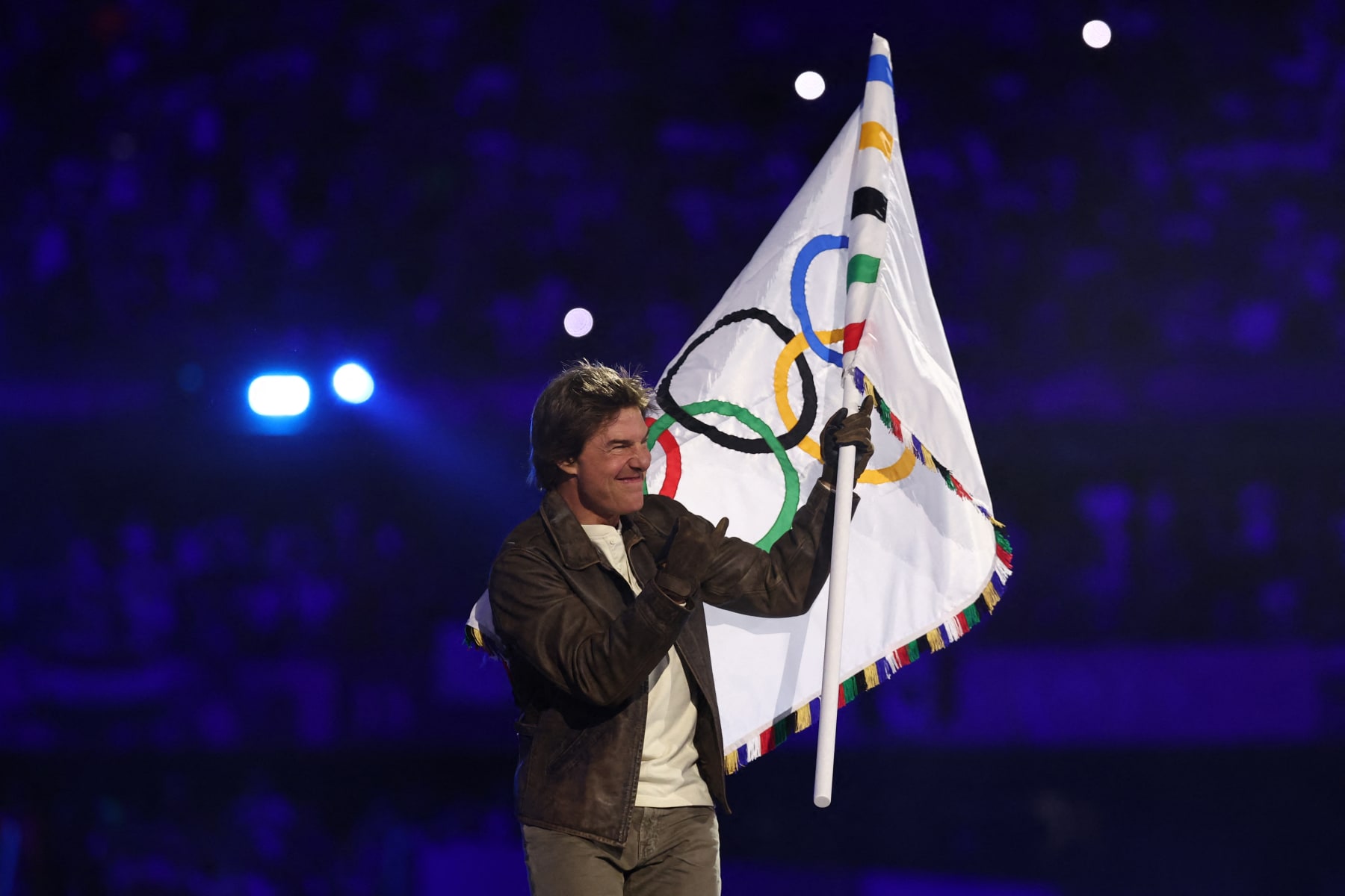 TOPSHOT - US' actor Tom Cruise waves the Olympic flag during the closing ceremony of the Paris 2024 Olympic Games at the Stade de France, in Saint-Denis, in the outskirts of Paris, on August 11, 2024. (Photo by Franck FIFE / AFP) (Photo by FRANCK FIFE/AFP via Getty Images)