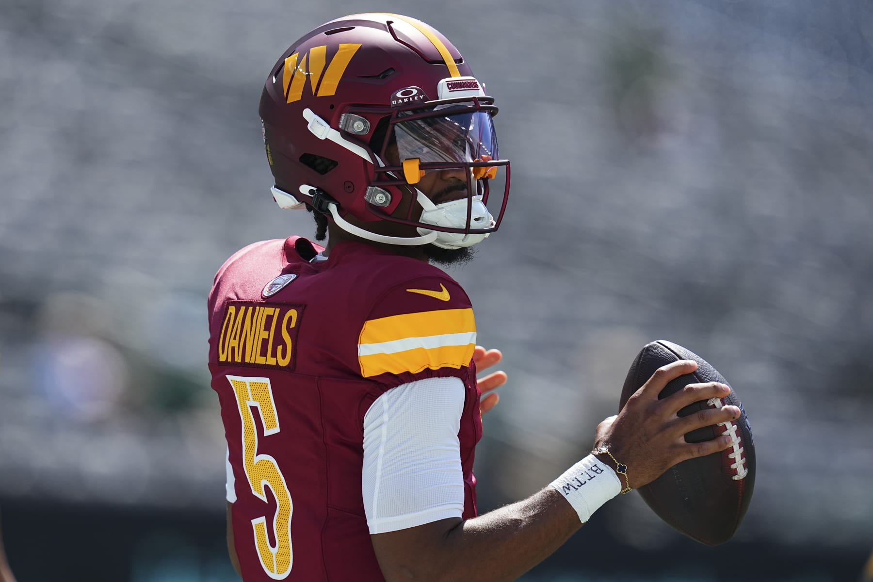 EAST RUTHERFORD, NEW JERSEY - AUGUST 10: Jayden Daniels #5 of the Washington Commanders looks on against the New York Jets during the preseason game at MetLife Stadium on August 10, 2024 in East Rutherford, New Jersey. The Jets defeated the Commanders 20-17. (Photo by Mitchell Leff/Getty Images)