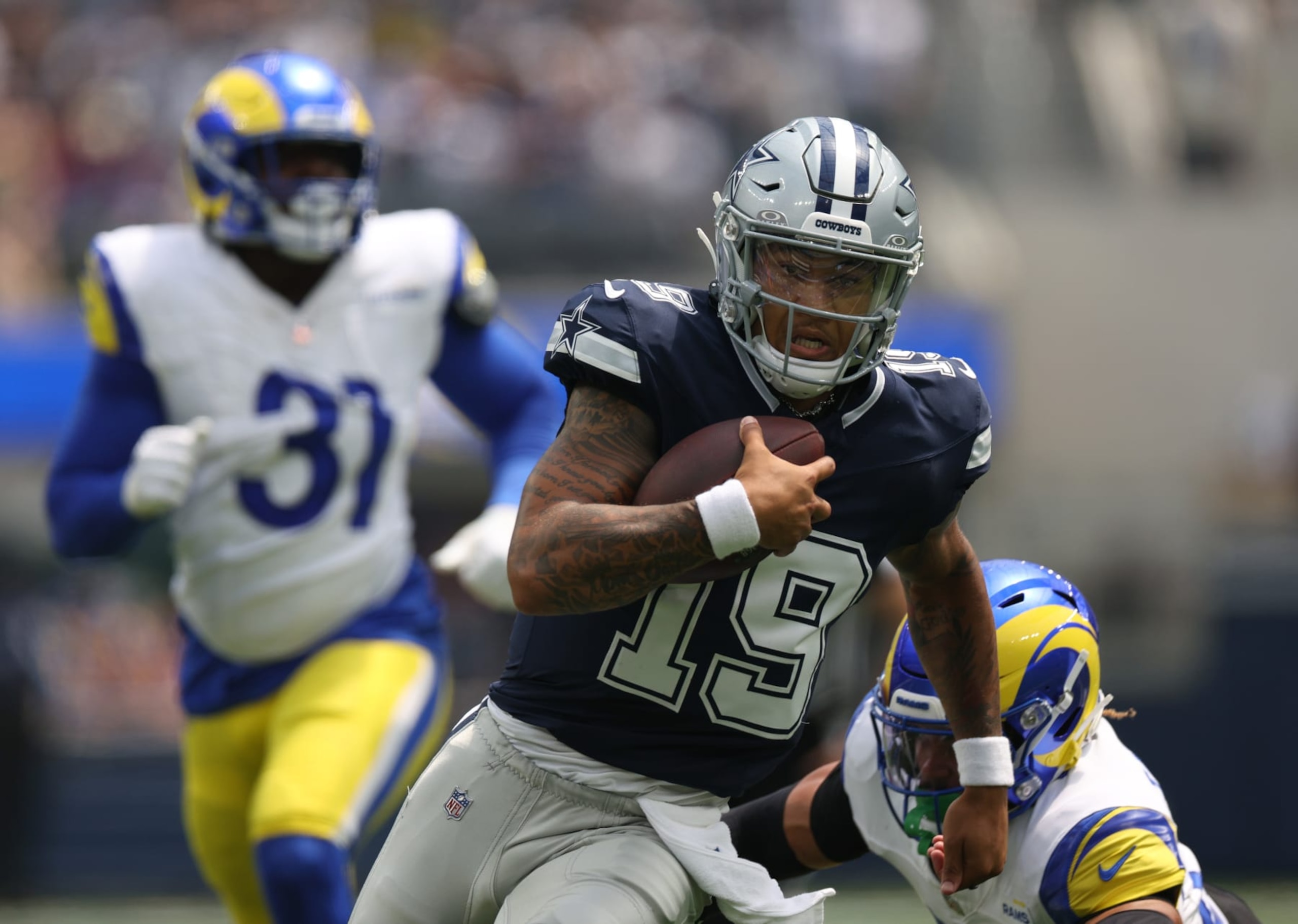 INGLEWOOD, CALIFORNIA - AUGUST 11: Trey Lance #19 of the Dallas Cowboys scrambles out of the pocket during the first half against the Los Angeles Rams in a preseason game at SoFi Stadium on August 11, 2024 in Inglewood, California. (Photo by Harry How/Getty Images)