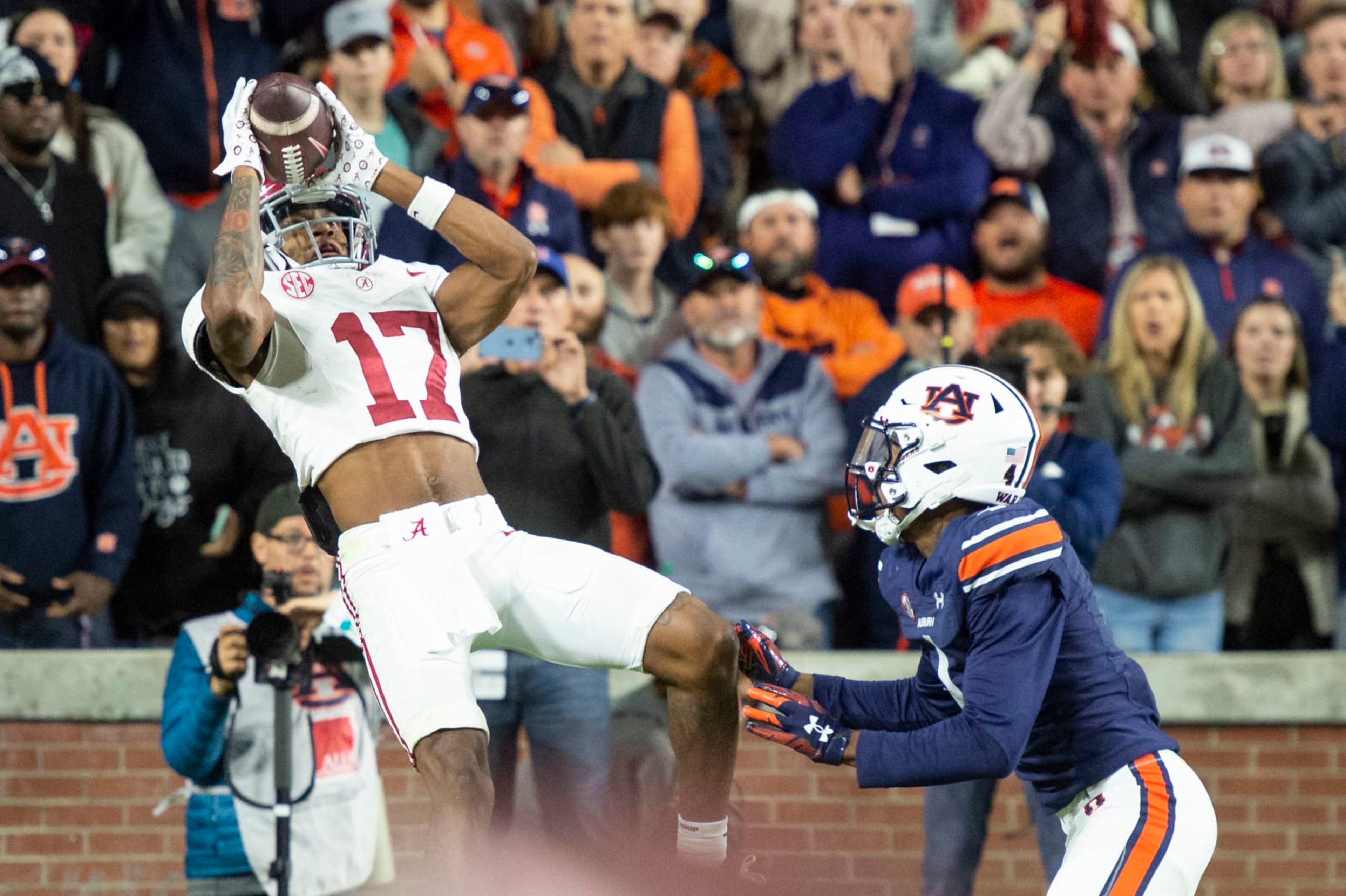 AUBURN, ALABAMA - NOVEMBER 25: Wide receiver Isaiah Bond #17 of the Alabama Crimson Tide catches a pass for a touchdown in front of cornerback D.J. James #4 of the Auburn Tigers during the second half of play at Jordan-Hare Stadium on November 25, 2023 in Auburn, Alabama. (Photo by Michael Chang/Getty Images)