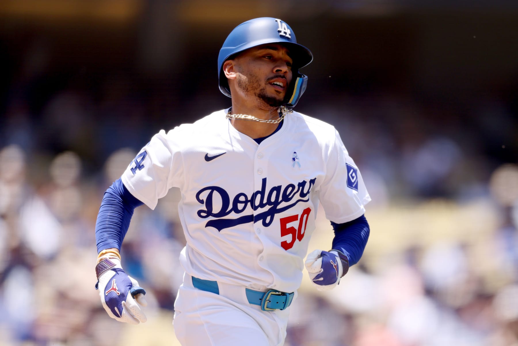LOS ANGELES, CALIFORNIA - JUNE 16: Mookie Betts #50 of the Los Angeles Dodgers runs to first base during the first inning against the Kansas City Royals at Dodger Stadium on June 16, 2024 in Los Angeles, California. (Photo by Katelyn Mulcahy/Getty Images)