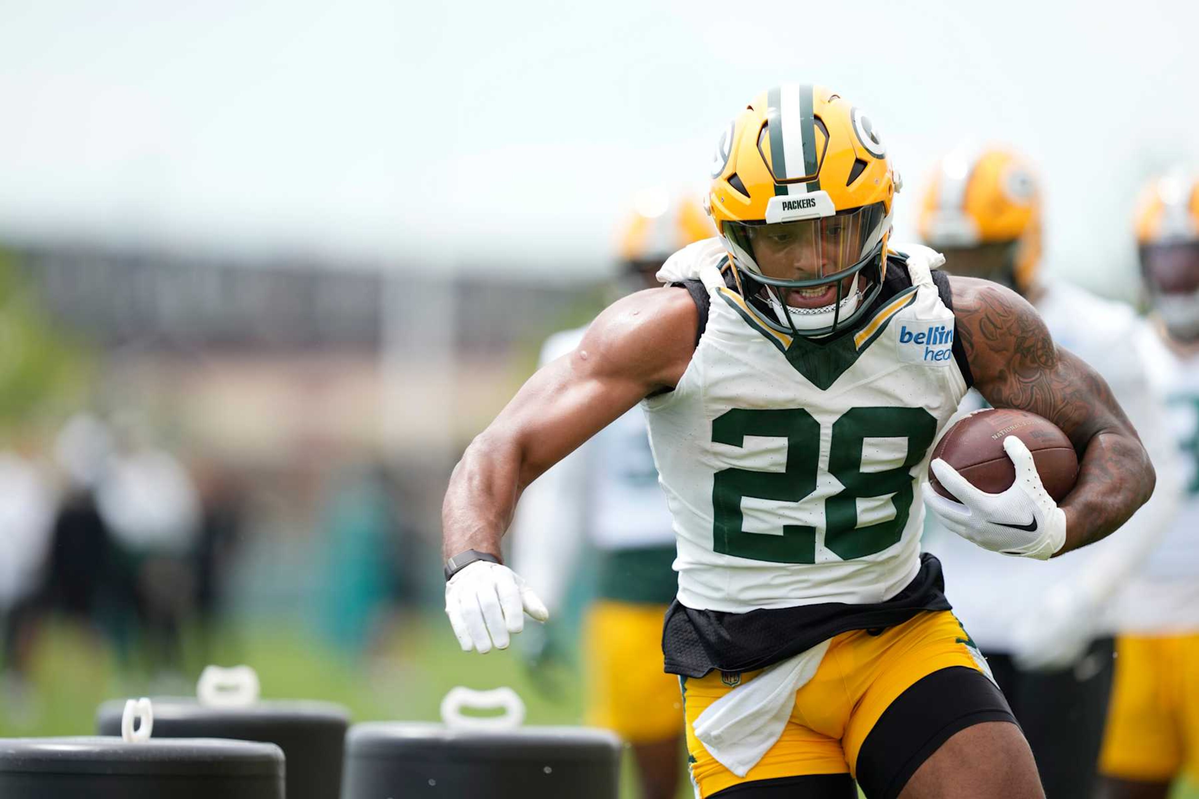 GREEN BAY, WISCONSIN - JUNE 11: AJ Dillon #28 of the Green Bay Packers participates in drills during the Green Bay Packers Minicamp at Ray Nitschke Field on June 11, 2024 in Green Bay, Wisconsin. (Photo by Patrick McDermott/Getty Images)