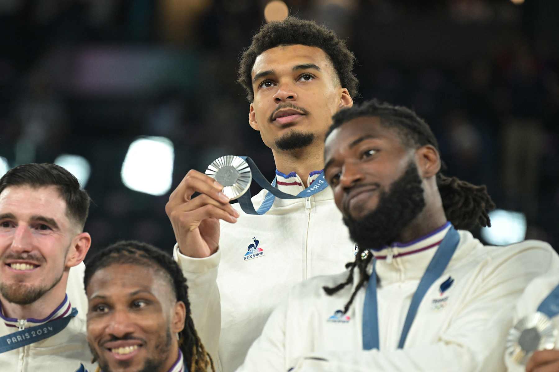 Silver medallists (From L) France's #12 Nando De Colo, France's #06 Andrew Albicy, France's #32 Victor Wembanyama and France's #26 Mathias Lessort pose on the podium after the men's Gold Medal basketball match between France and USA during the Paris 2024 Olympic Games at the Bercy  Arena in Paris on August 10, 2024. (Photo by Damien MEYER / AFP) (Photo by DAMIEN MEYER/AFP via Getty Images)