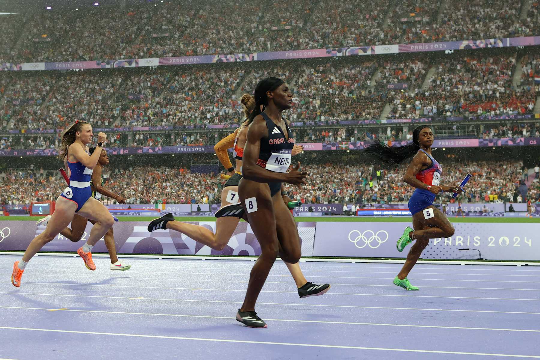 PARIS, FRANCE - AUGUST 09: Sha'carri Richardson looks across to Daryll Neita of Team Great Britain before she accelerates to the line to win the Women's 4 x 100m Relay Final for the USA on day fourteen of the Olympic Games Paris 2024 at Stade de France on August 09, 2024 in Paris, France. (Photo by Richard Heathcote/Getty Images)