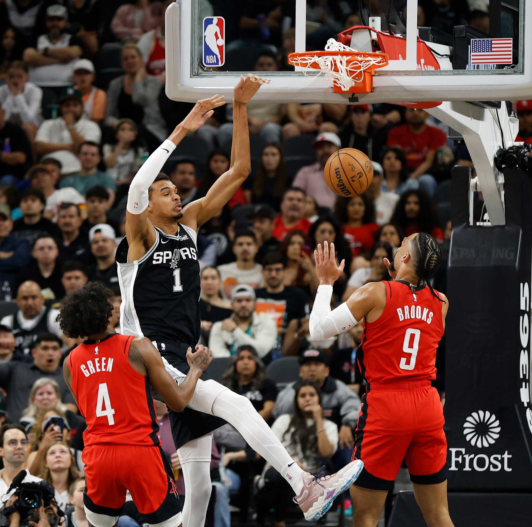 SAN ANTONIO, TX - MARCH 12:   Victor Wembanyama #1 of the San Antonio Spurs dunks over Dillon Brooks #9 of the Houston Rockets in the first half at Frost Bank Center on March 12, 2024 in San Antonio, Texas. NOTE TO USER: User expressly acknowledges and agrees that, by downloading and or using this photograph, User is consenting to terms and conditions of the Getty Images License Agreement. (Photo by Ronald Cortes/Getty Images)