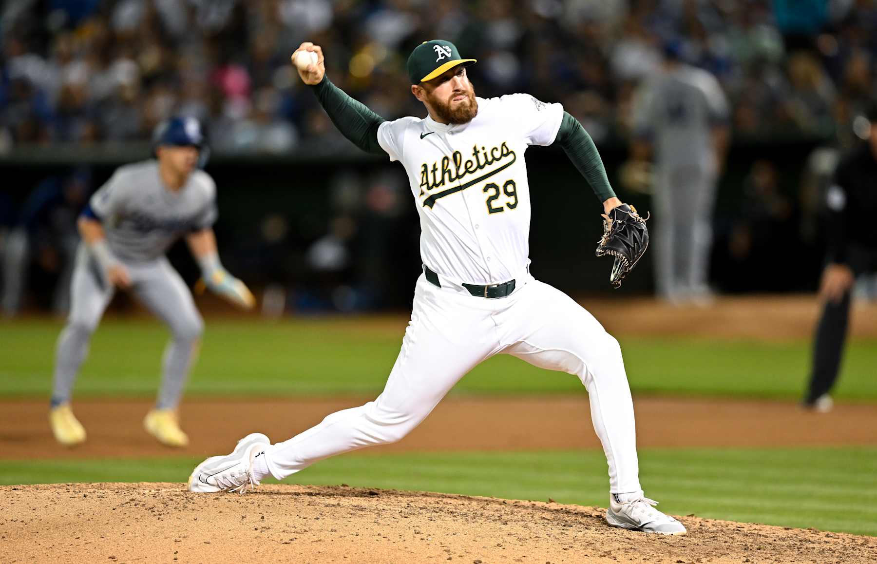 OAKLAND, CALIFORNIA - AUGUST 02: Austin Adams #29 of Oakland Athletics pitches in the top of the seventh inning during the regular season game against the Los Angeles Dodgers at the Oakland Coliseum on August 2, 2024 in Oakland, California.  (Photo by Gene Wang/Getty Images)