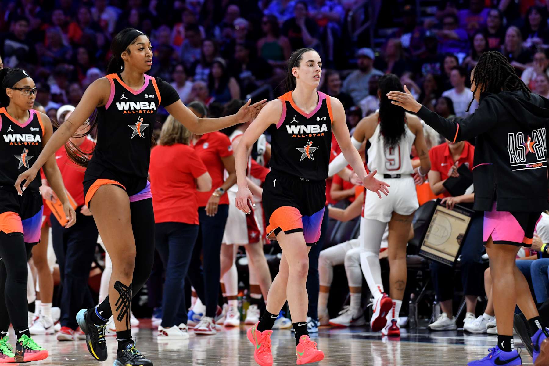 PHOENIX, AZ - JULY 20: Angel Reese #5 pats Caitlin Clark #22 of Team WNBA on the back during the 2024 WNBA All Star Game on July 20, 2024 at Footprint Center in Phoenix, Arizona. NOTE TO USER: User expressly acknowledges and agrees that, by downloading and or using this photograph, user is consenting to the terms and conditions of the Getty Images License Agreement. Mandatory Copyright Notice: Copyright 2024 NBAE (Photo by Juan Ocampo/NBAE via Getty Images)