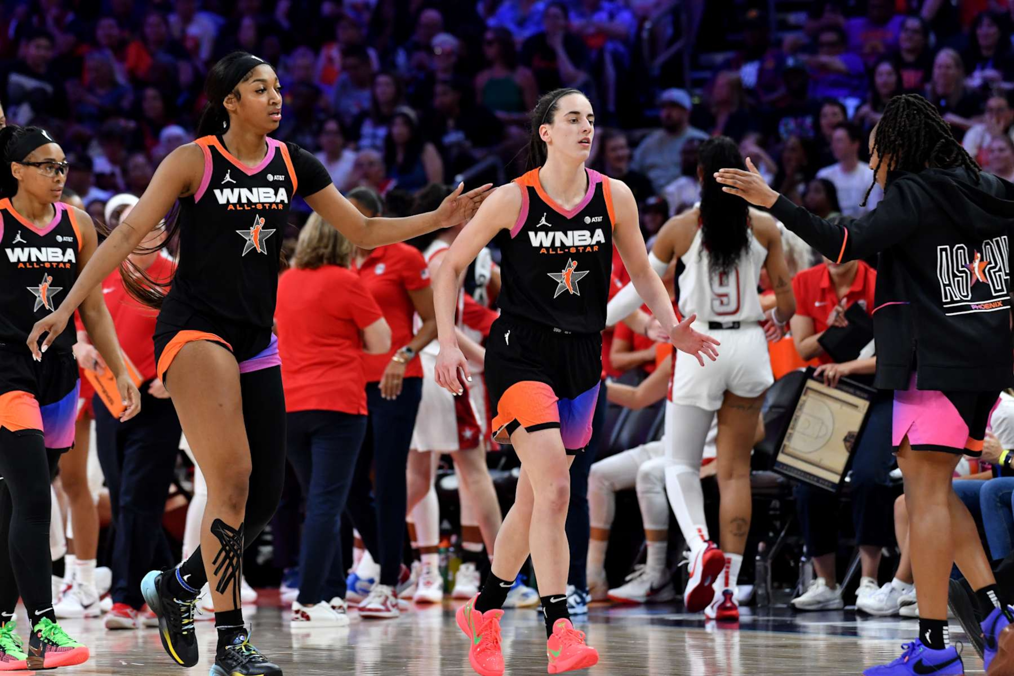 PHOENIX, AZ - JULY 20: Angel Reese #5 pats Caitlin Clark #22 of Team WNBA on the back during the 2024 WNBA All Star Game on July 20, 2024 at Footprint Center in Phoenix, Arizona. NOTE TO USER: User expressly acknowledges and agrees that, by downloading and or using this photograph, user is consenting to the terms and conditions of the Getty Images License Agreement. Mandatory Copyright Notice: Copyright 2024 NBAE (Photo by Juan Ocampo/NBAE via Getty Images)