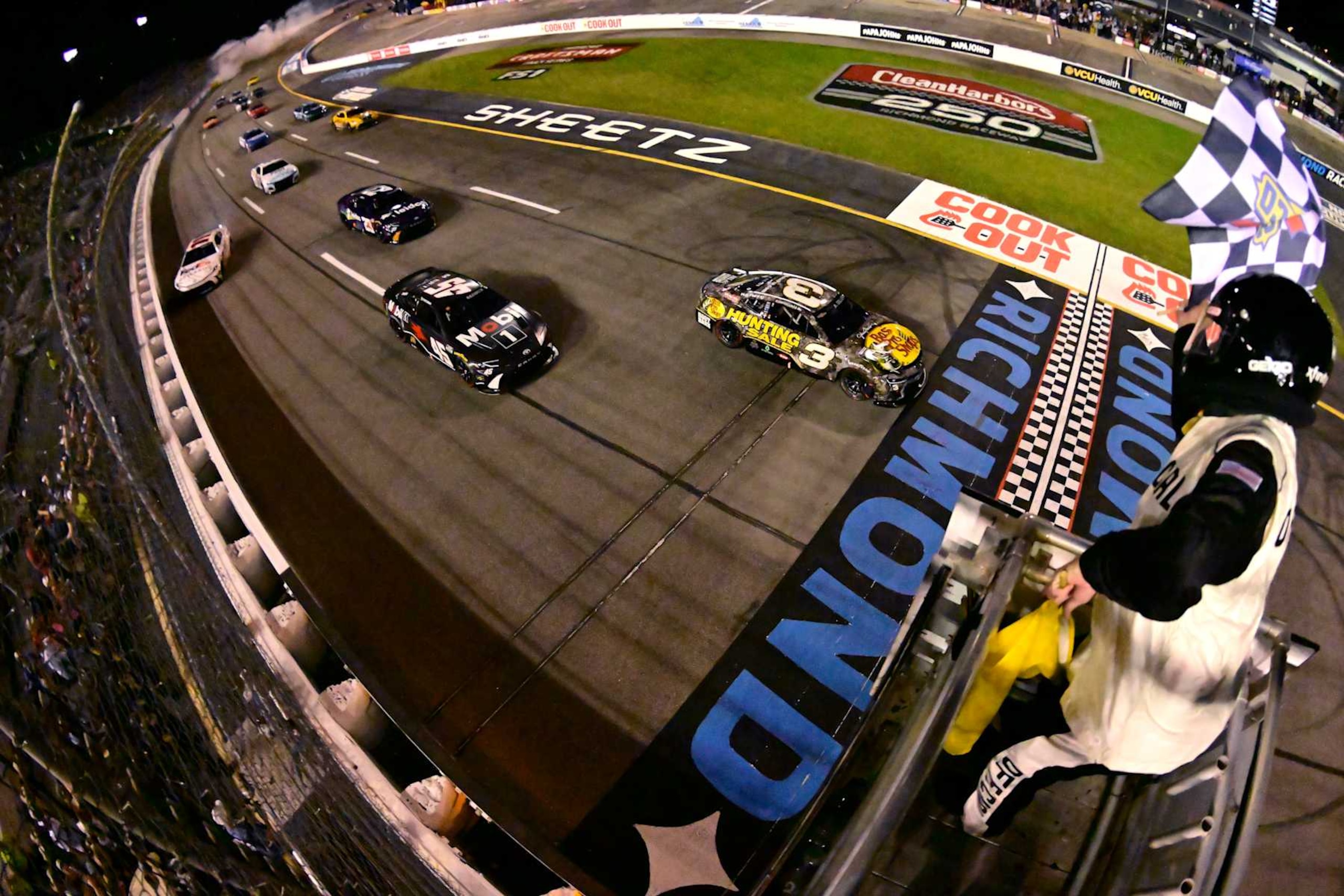 RICHMOND, VIRGINIA - AUGUST 11: Austin Dillon, driver of the #3 Bass Pro Shops Chevrolet, takes the checkered flag under caution to win the NASCAR Cup Series Cook Out 400 at Richmond Raceway on August 11, 2024 in Richmond, Virginia. (Photo by Logan Whitton/Getty Images)