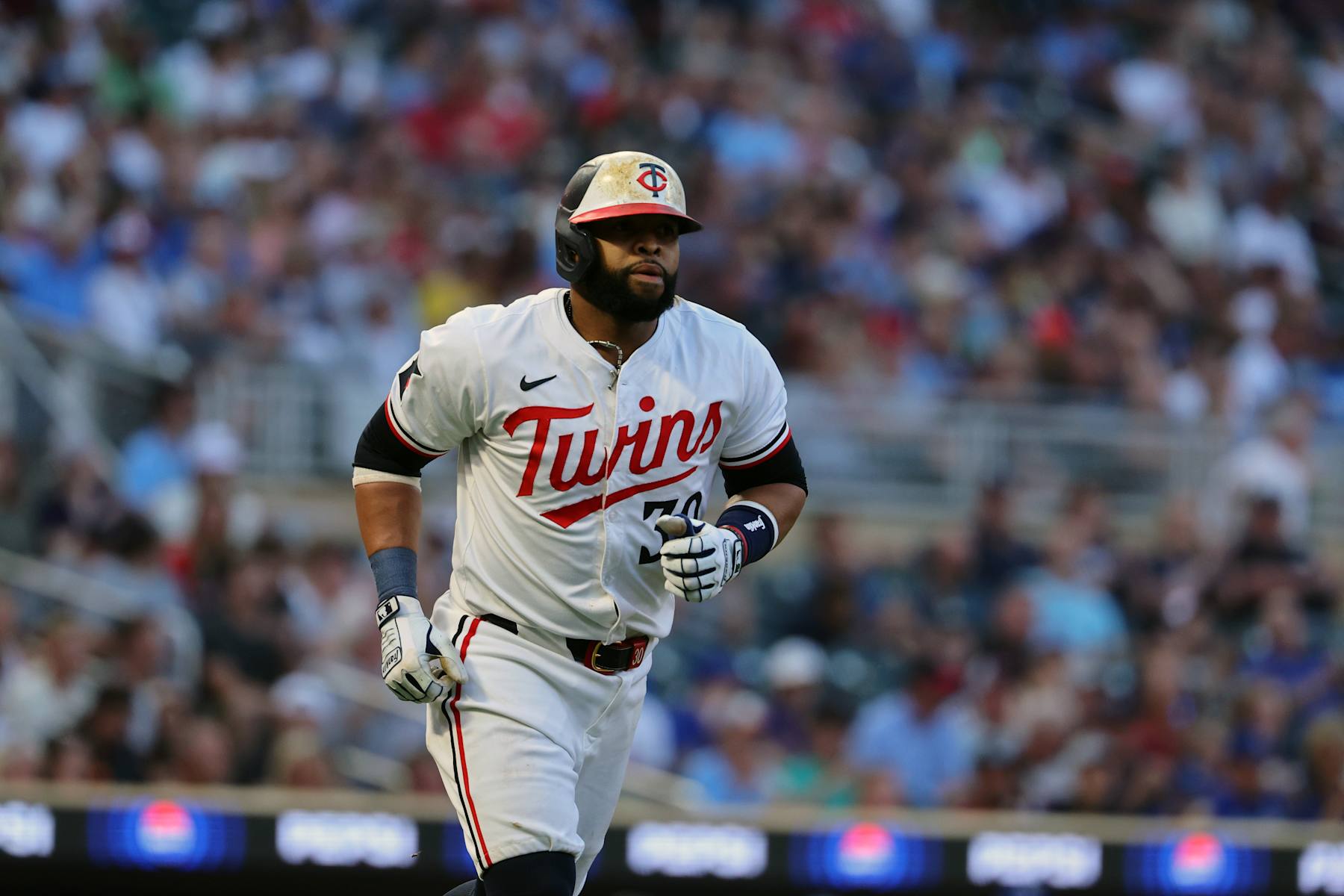 MINNEAPOLIS, MN - AUGUST 13: Carlos Santana #30 of the Minnesota Twins walks in the fifth inning against the Kansas City Royals at Target Field on August 13, 2024 in Minneapolis, Minnesota.(Photo by Adam Bettcher/Getty Images)
