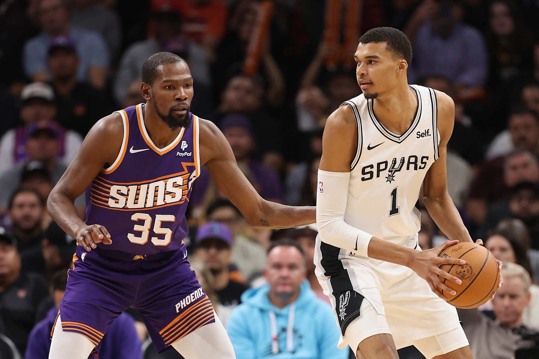 PHOENIX, ARIZONA - NOVEMBER 02: Victor Wembanyama #1 of the San Antonio Spurs handles the ball against Kevin Durant #35 of the Phoenix Suns during the second half of the NBA game at Footprint Center on November 02, 2023 in Phoenix, Arizona. The Spurs defeated the Suns 132-121.  NOTE TO USER: User expressly acknowledges and agrees that, by downloading and or using this photograph, User is consenting to the terms and conditions of the Getty Images License Agreement.  (Photo by Christian Petersen/Getty Images)