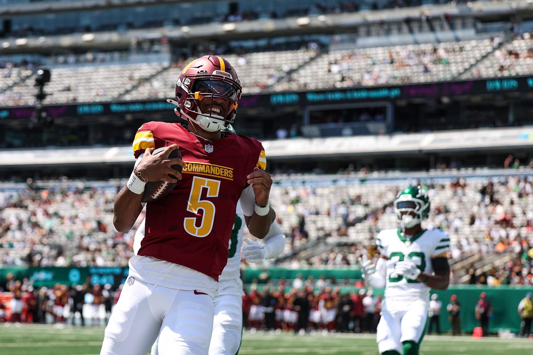 EAST RUTHERFORD, NJ - AUGUST 10: Jayden Daniels #5 of the Washington Commanders runs the ball for a touchdown during an NFL football game against the New York Jets at MetLife Stadium on August 10, 2024 in East Rutherford, NJ. (Photo by Perry Knotts/Getty Images)