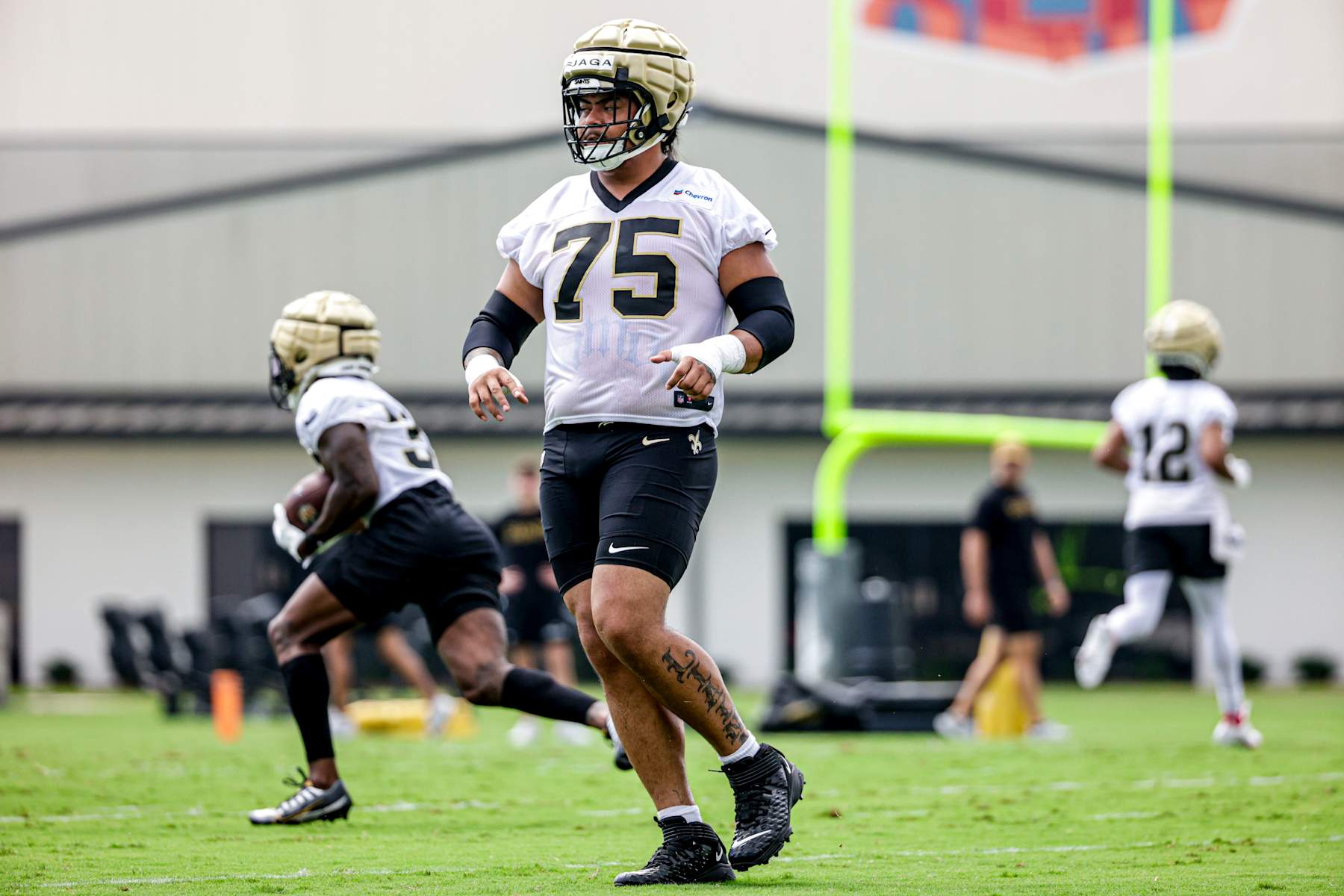 METAIRIE, LOUISIANA - MAY 28: Taliese Fuaga (75) of the New Orleans Saints attends OTA offseason workout at the New Orleans Saints Practice Facility on May 28, 2024 in Metaire, Louisiana. (Photo by Derick E. Hingle/Getty Images)
