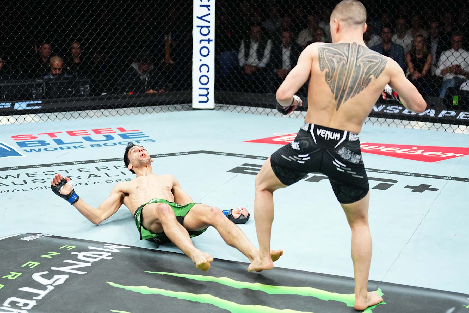 PERTH, AUSTRALIA - AUGUST 18: Kai Kara-France of New Zealand drops Steve Erceg of Australia with a punch in a flyweight fight during the UFC 305 event at RAC Arena on August 18, 2024 in Perth, Australia. (Photo by Jeff Bottari/Zuffa LLC)