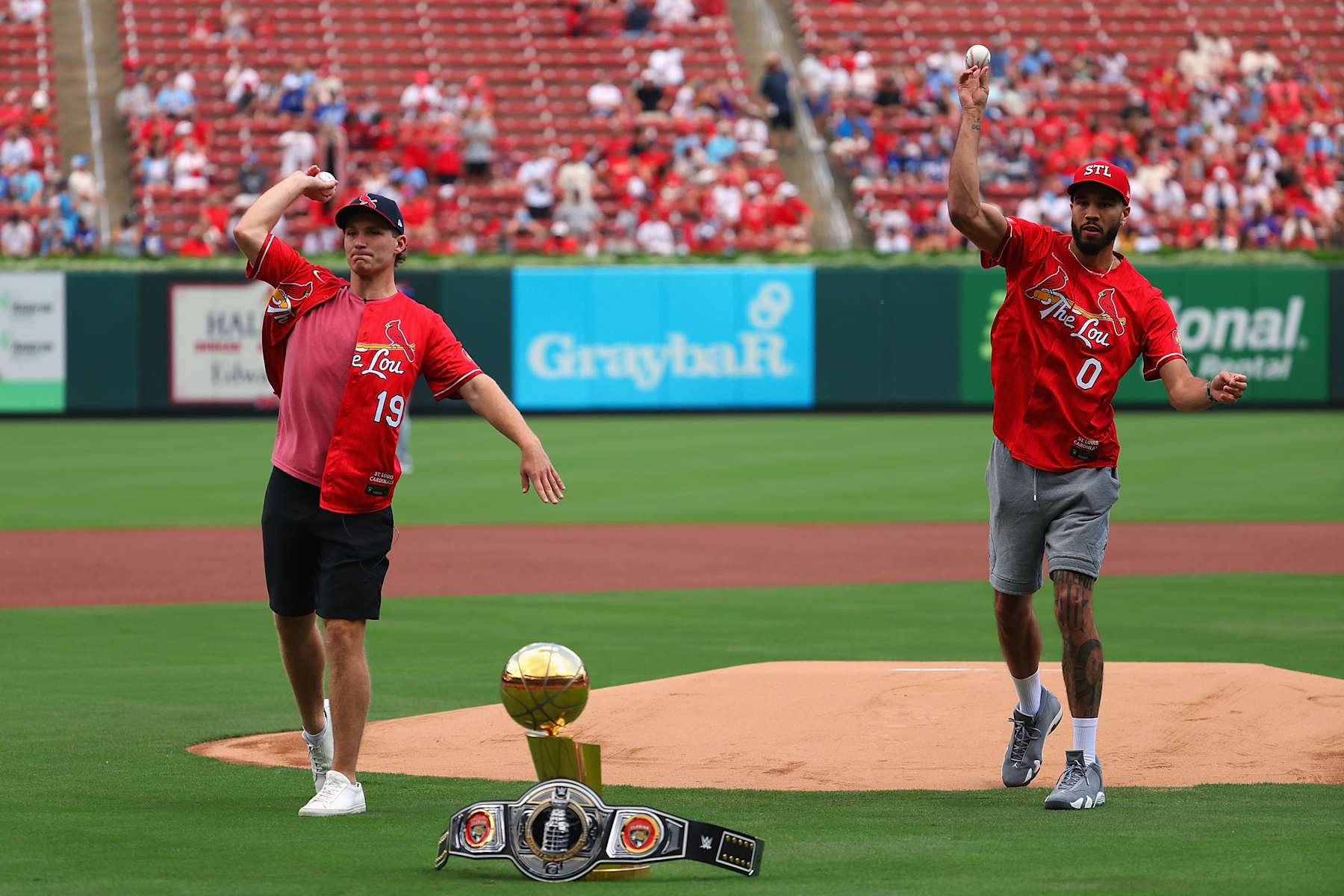 ST LOUIS, MISSOURI - AUGUST 18: St. Louis natives Stanley Cup Champion Matthew Tkachuk #19 of the Florida Panthers and NBL Finals Champion Jayson Tatum #0 of the Boston Celtics throw out the first pitches prior to a game between the St. Louis Cardinals and the Los Angeles Dodgers at Busch Stadium on August 18, 2024 in St Louis, Missouri. (Photo by Dilip Vishwanat/Getty Images)
