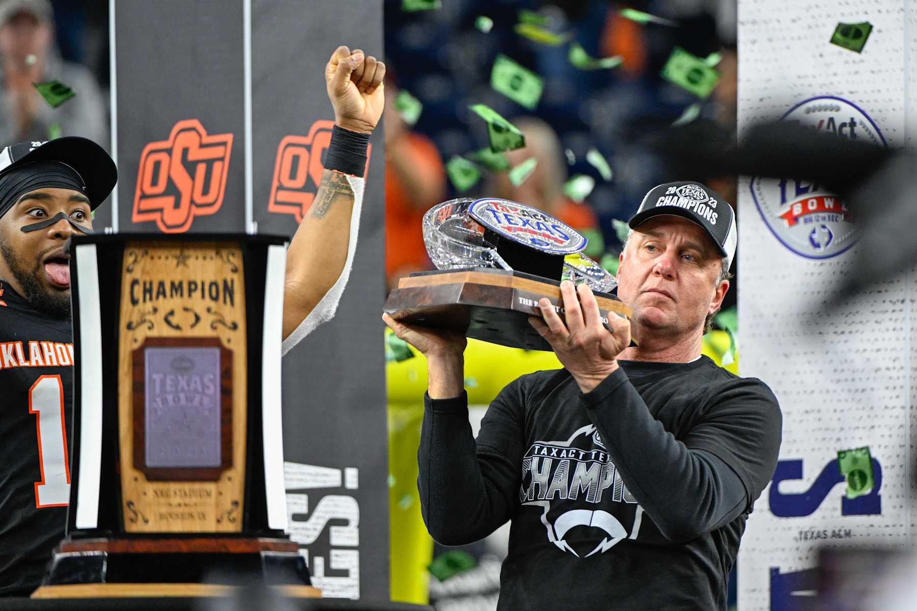 HOUSTON, TX - DECEMBER 27: Oklahoma State Cowboys head coach Mike Gundy holds the trophy for winning the TaxAct Texas Bowl between the Texas A&M Aggies and Oklahoma State Cowboys at NRG Stadium on December 27, 2023 in Houston, Texas. (Photo by Ken Murray/Icon Sportswire via Getty Images)