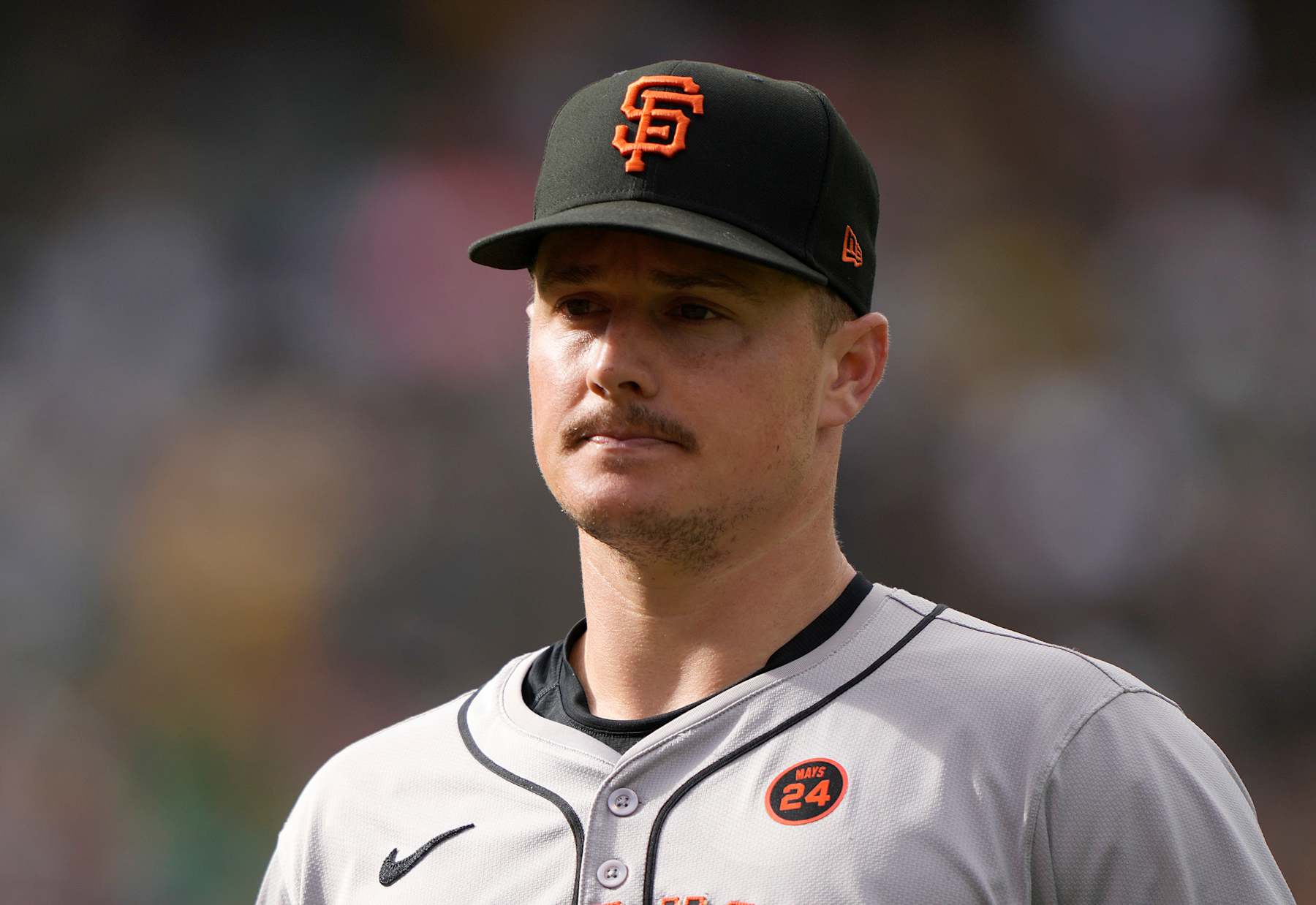 OAKLAND, CALIFORNIA - AUGUST 17: Matt Chapman #26 of the San Francisco Giants walks off the field at the end of the fourth inning against the Oakland Athletics at the Oakland Coliseum on August 17, 2024 in Oakland, California. Players in major league baseball for the first time is wearing their jersey numbers on their caps. (Photo by Thearon W. Henderson/Getty Images)