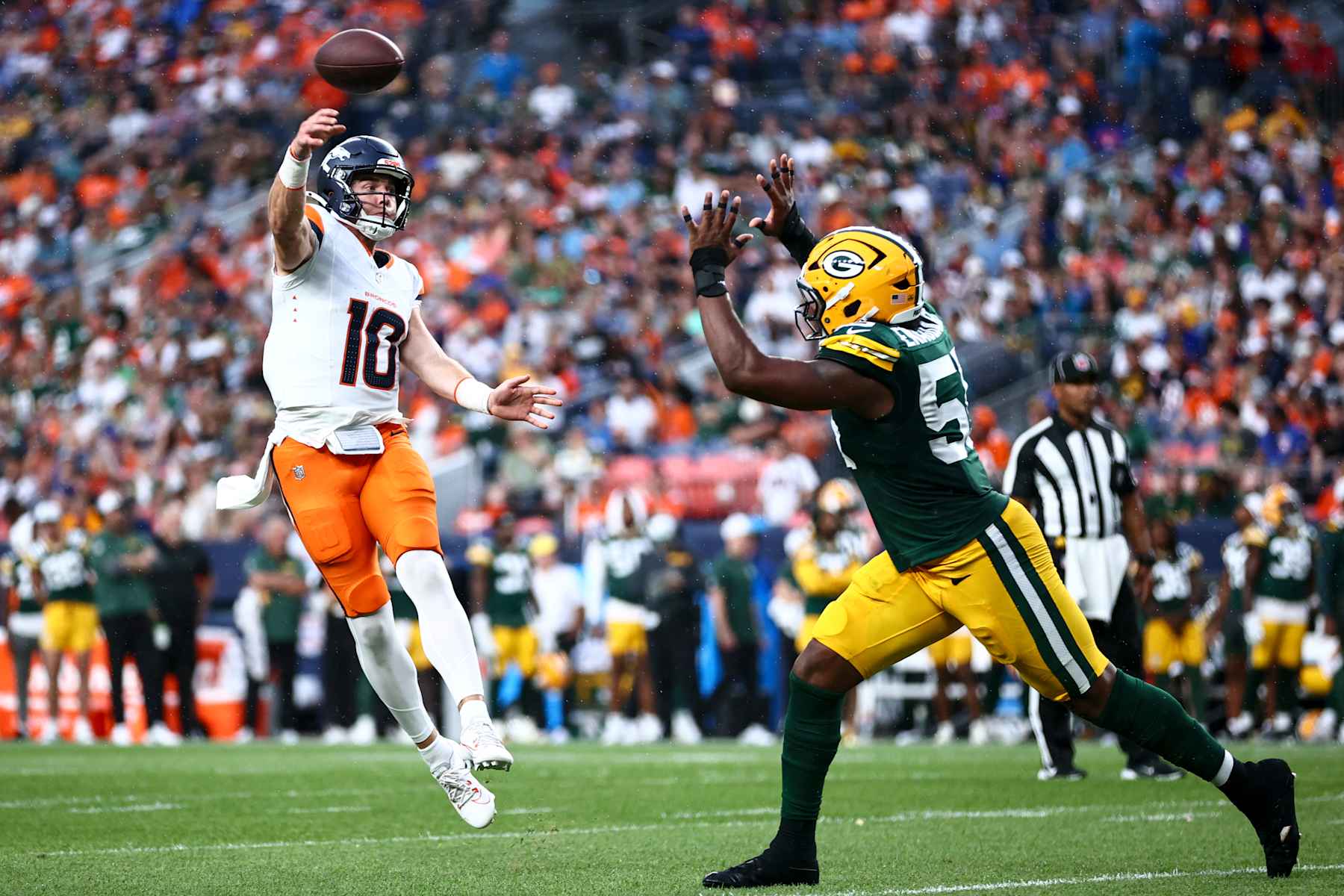 DENVER, COLORADO - AUGUST 18: Bo Nix #10 of the Denver Broncos throws a touchdown pass to Tim Patrick #12 in the second quarter during the preseason game against the Green Bay Packers at Empower Field At Mile High on August 18, 2024 in Denver, Colorado. (Photo by Tyler Schank/Getty Images)