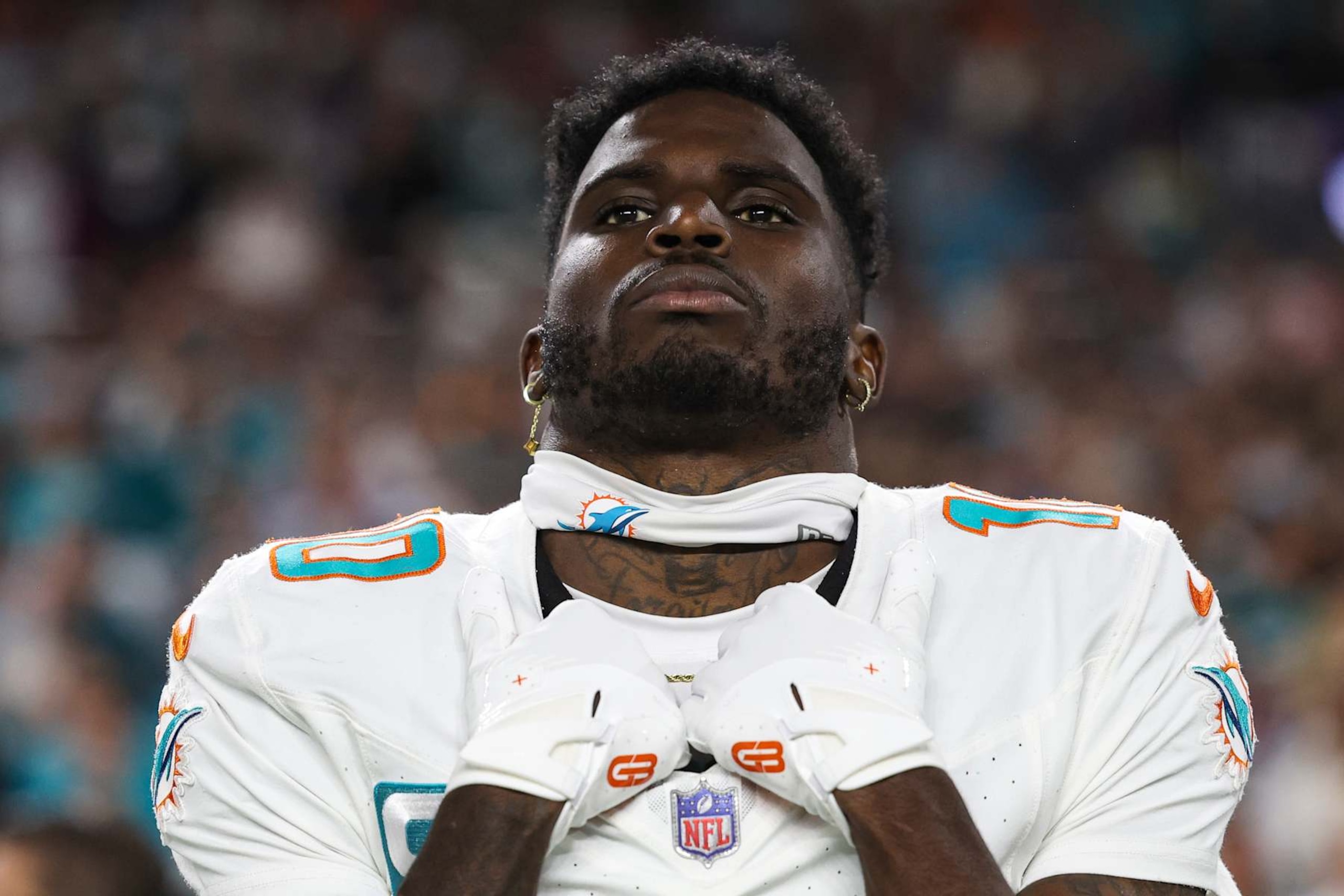 MIAMI GARDENS, FL - JANUARY 07: Tyreek Hill #10 of the Miami Dolphins looks on from the sideline during the national anthem prior to an NFL football game against the Buffalo Bills at Hard Rock Stadium on January 7, 2024 in Miami Gardens, Florida. (Photo by Perry Knotts/Getty Images)
