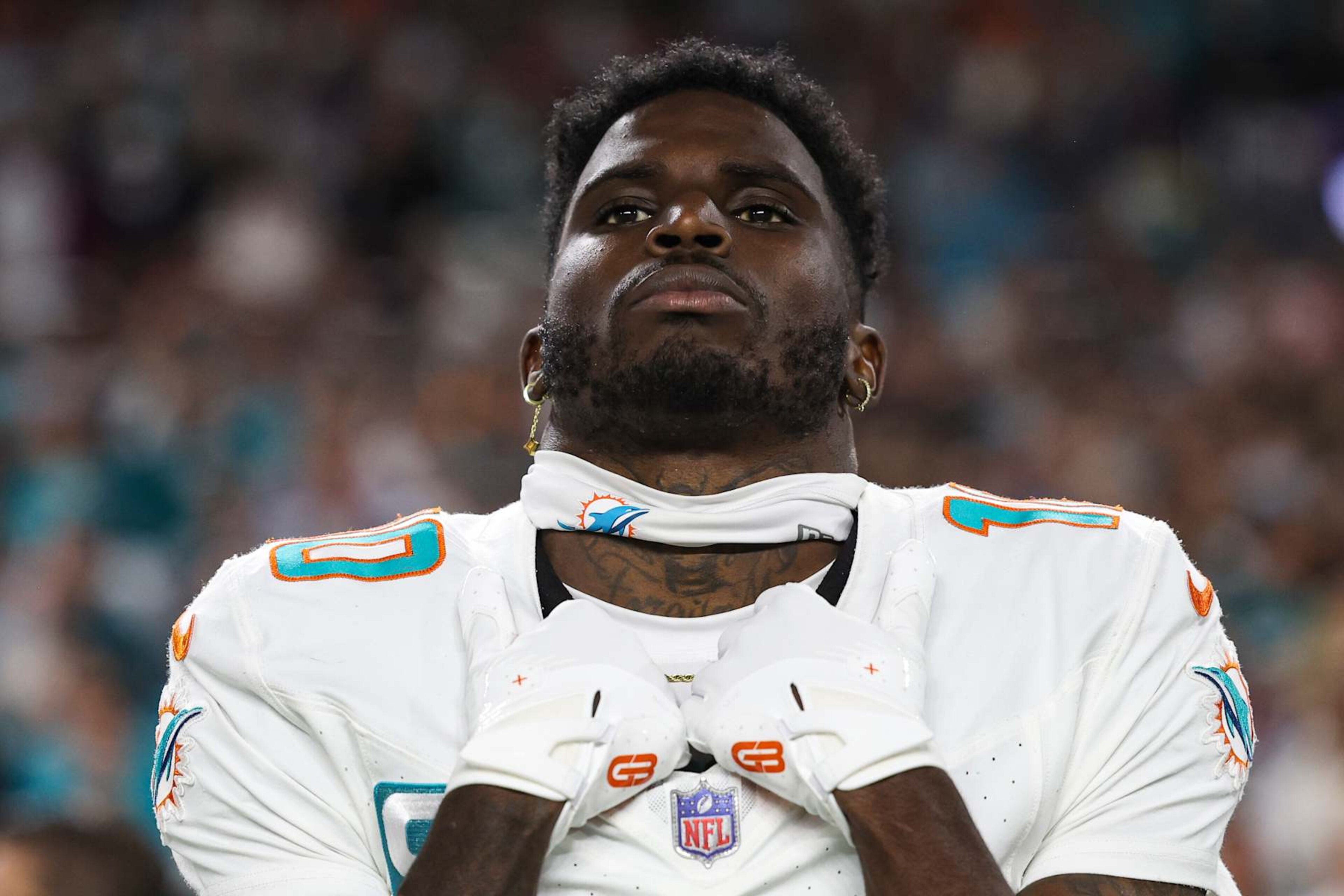 MIAMI GARDENS, FL - JANUARY 07: Tyreek Hill #10 of the Miami Dolphins looks on from the sideline during the national anthem prior to an NFL football game against the Buffalo Bills at Hard Rock Stadium on January 7, 2024 in Miami Gardens, Florida. (Photo by Perry Knotts/Getty Images)