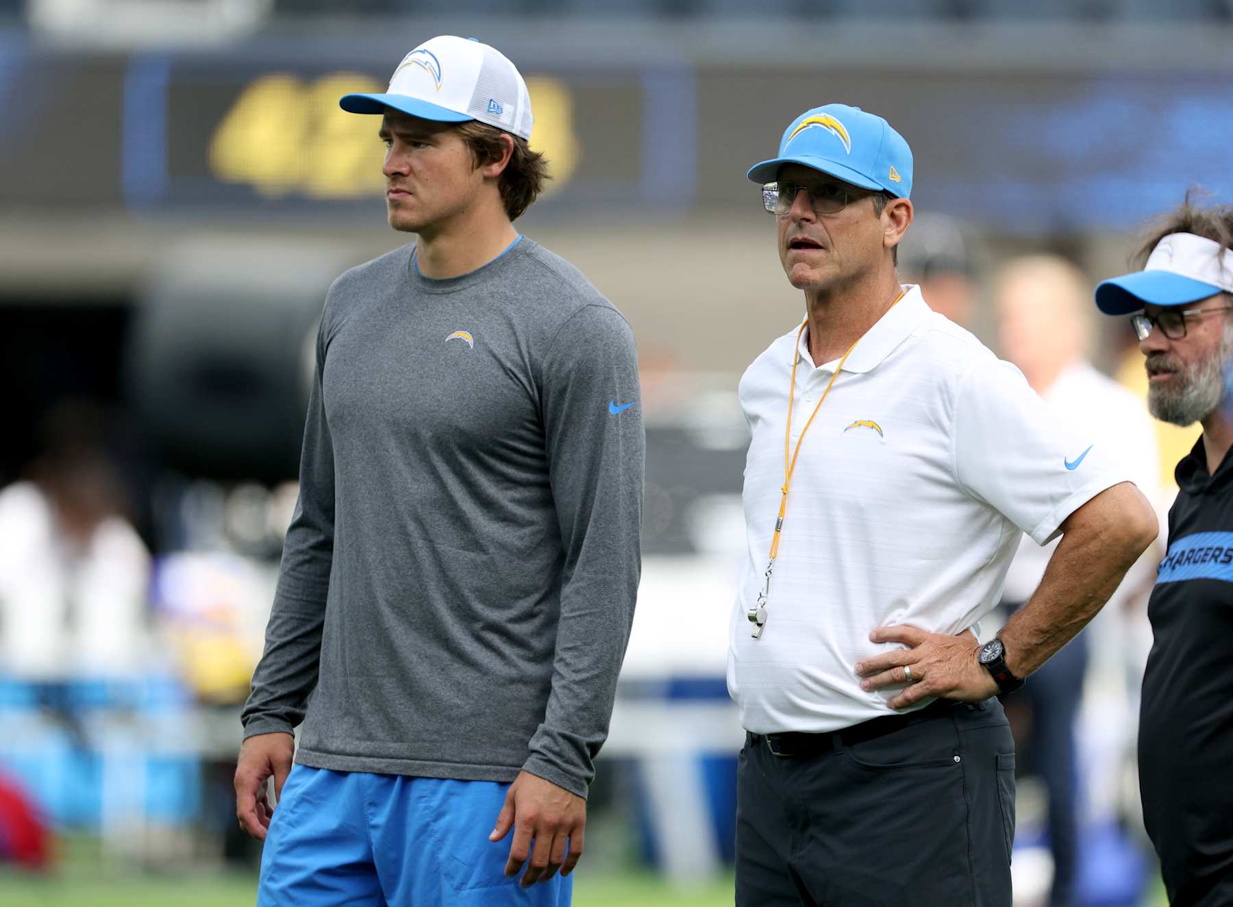 INGLEWOOD, CALIFORNIA - AUGUST 17: Justin Herbert #10 and Jim Harbaugh of the Los Angeles Chargers watch warm up before a preseason game against the Los Angeles Rams at SoFi Stadium on August 17, 2024 in Inglewood, California. (Photo by Harry How/Getty Images)