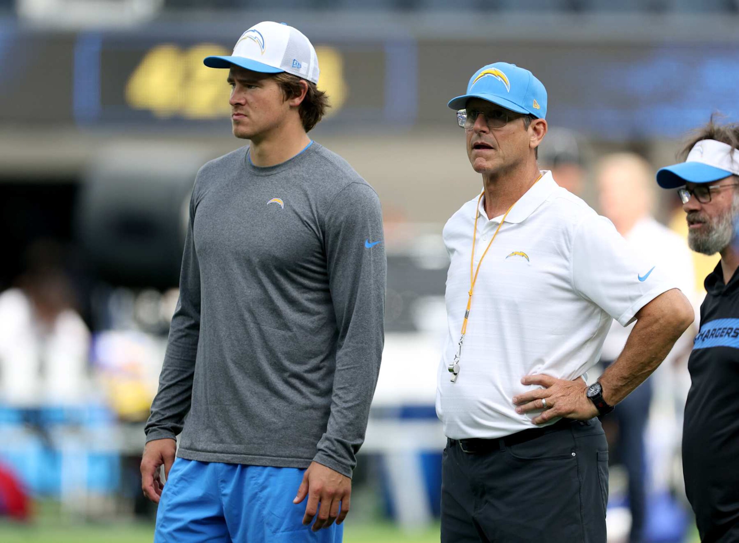 INGLEWOOD, CALIFORNIA - AUGUST 17: Justin Herbert #10 and Jim Harbaugh of the Los Angeles Chargers watch warm up before a preseason game against the Los Angeles Rams at SoFi Stadium on August 17, 2024 in Inglewood, California. (Photo by Harry How/Getty Images)