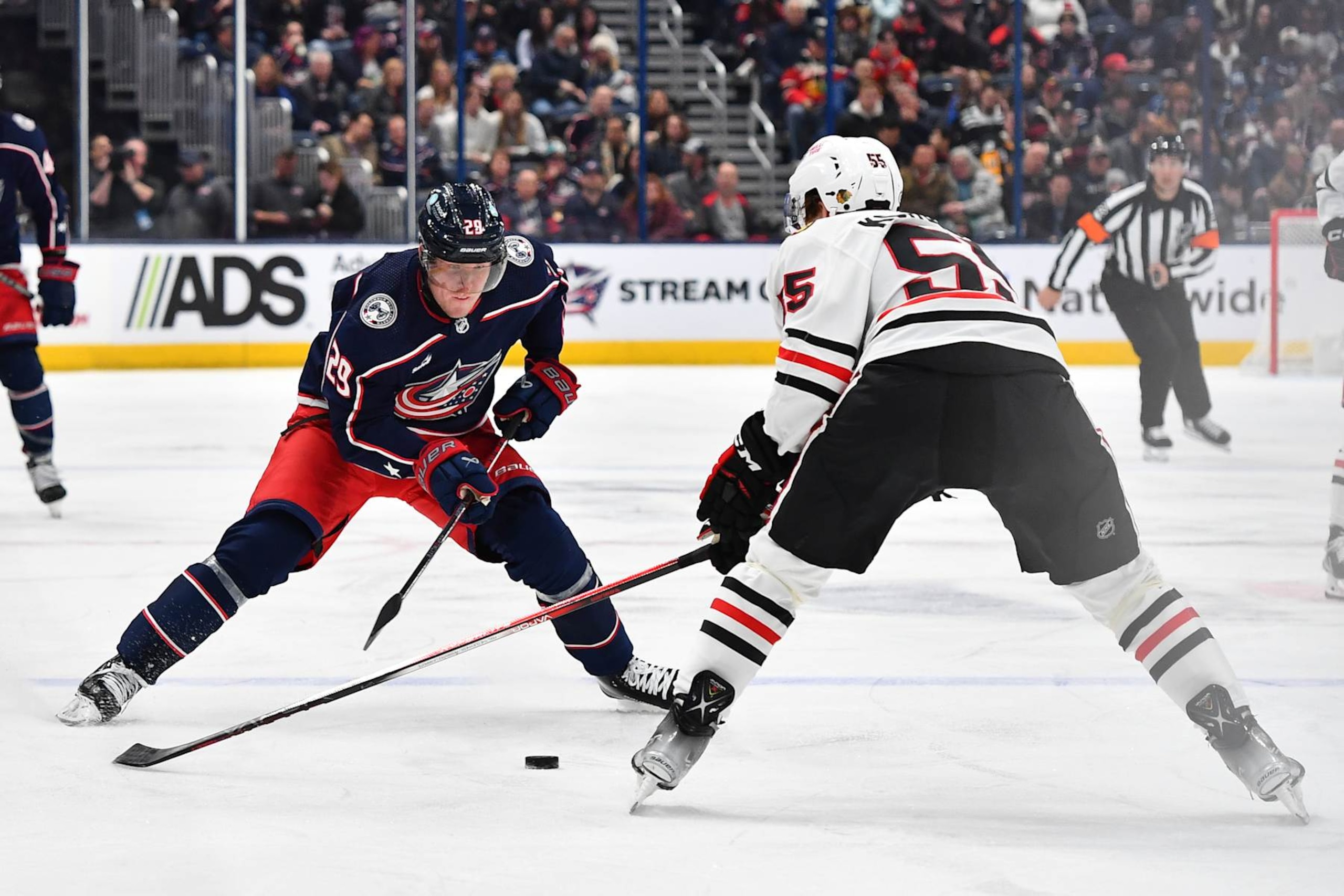 COLUMBUS, OHIO - NOVEMBER 22: Patrik Laine #29 of the Columbus Blue Jackets skates with the puck as Kevin Korchinski #55 of the Chicago Blackhawks defends during the first period of a game at Nationwide Arena on November 22, 2023 in Columbus, Ohio. (Photo by Ben Jackson/NHLI via Getty Images)