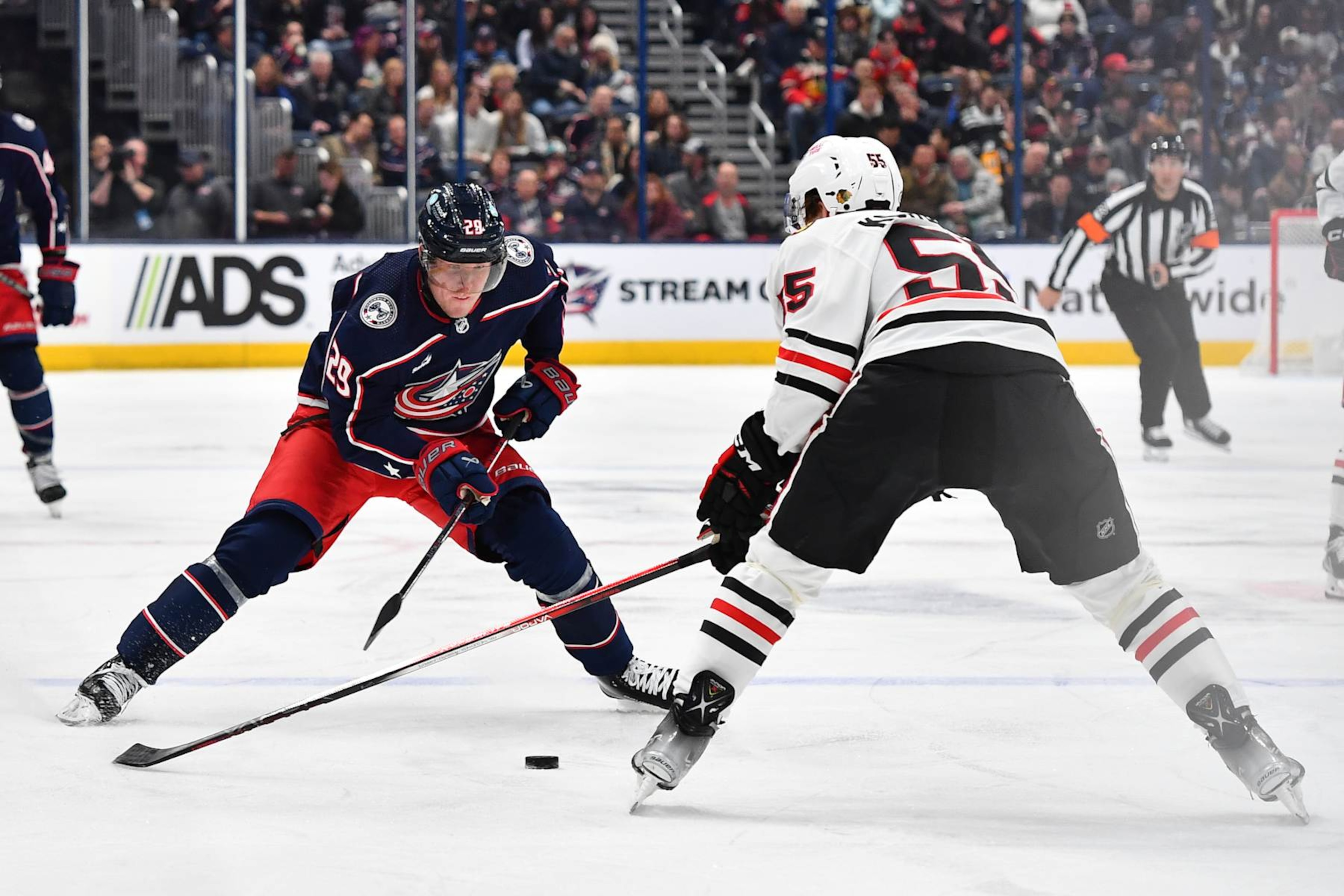 COLUMBUS, OHIO - NOVEMBER 22: Patrik Laine #29 of the Columbus Blue Jackets skates with the puck as Kevin Korchinski #55 of the Chicago Blackhawks defends during the first period of a game at Nationwide Arena on November 22, 2023 in Columbus, Ohio. (Photo by Ben Jackson/NHLI via Getty Images)