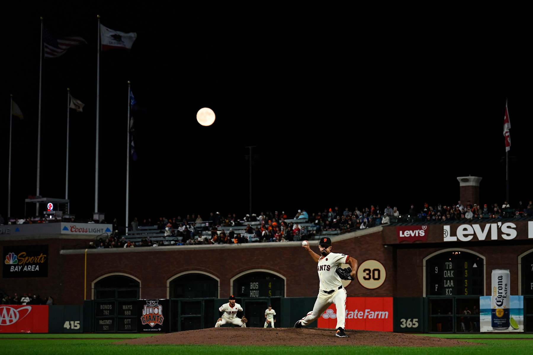 SAN FRANCISCO, CALIFORNIA - AUGUST 19: A blue supermoon rises over the field as Jordan Hicks #12 of the San Francisco Giants throws a pitch against the Chicago White Sox in the ninth inning at Oracle Park on August 19, 2024 in San Francisco, California. (Photo by Eakin Howard/Getty Images)