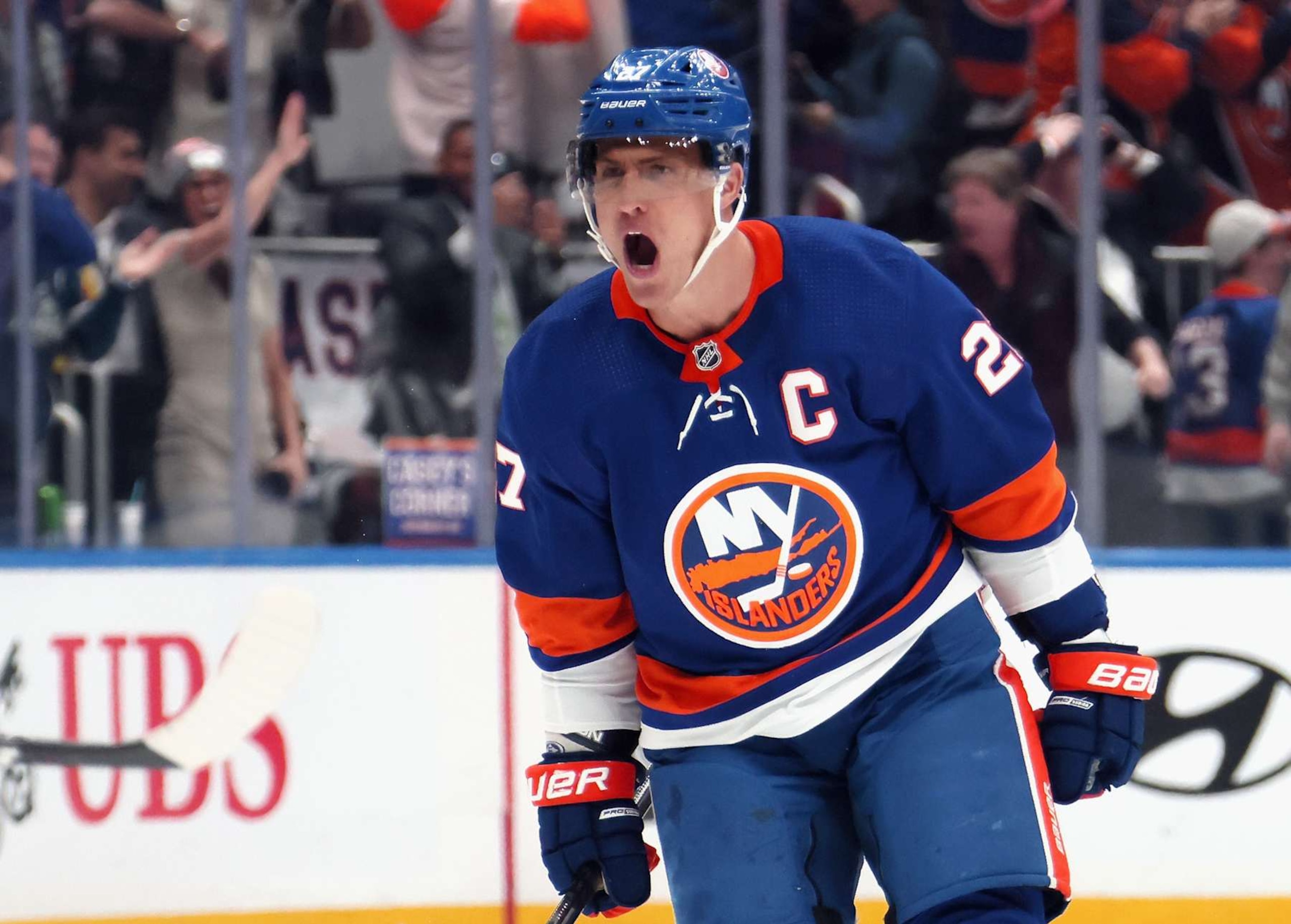 ELMONT, NEW YORK - APRIL 09: Anders Lee #27 of the New York Islanders celebrates his empty net goal against the New York Rangers at UBS Arena on April 09, 2024 in Elmont, New York. The Islanders defeated the Rangers 4-2. (Photo by Bruce Bennett/Getty Images)